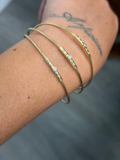 MAUBOUSSIN PARÍS: Trío de pulseras rígidas de oro amarillo de 18k y diamantes, década de los 80