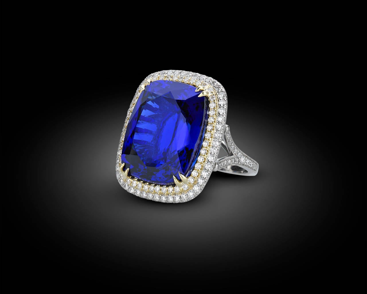 The striking and rare tanzanite in this breathtaking ring boasts the perfect, violetish-blue hue for which the best of these gems are so coveted. Weighing a remarkable 35.54 carats, the stone is perfectly complemented by 1.84 carats of white