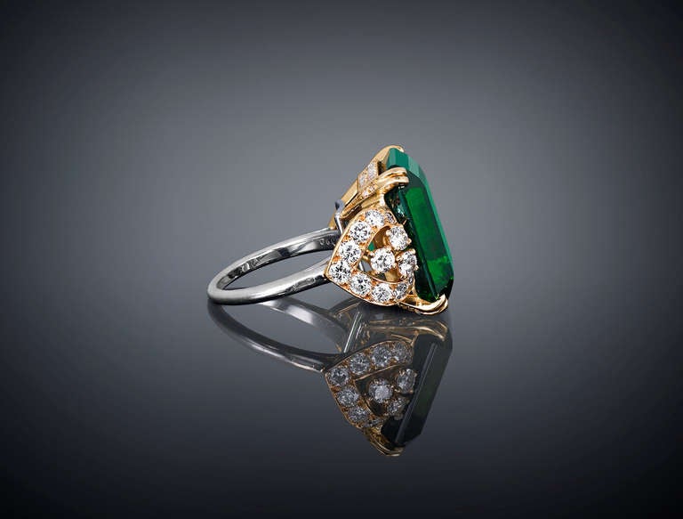 This captivating tourmaline and diamond ring from the House of Cartier is unlike any other. It features a magnificent green tourmaline weighing approximately 19.12 carats joined by approximately 2.06 carats of sparkling diamonds in an 18K yellow and