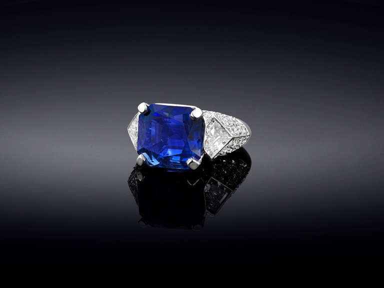 This important Cartier ring features a magnificent, natural Ceylon sapphire. This extraordinary 17.55-carat gem, which boasts the deep, velvety blue for which the best Ceylon sapphires are known, is flanked by two fine white shield-cut diamonds. The