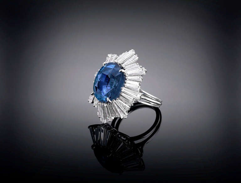 A truly stunning sapphire commands attention in this elegant ring. Weighing approximately 17.20 carats, this gem smolders with exceptional color, which is perfectly enhanced by approximately 3.50 carats of flashing diamonds that surround this jewel