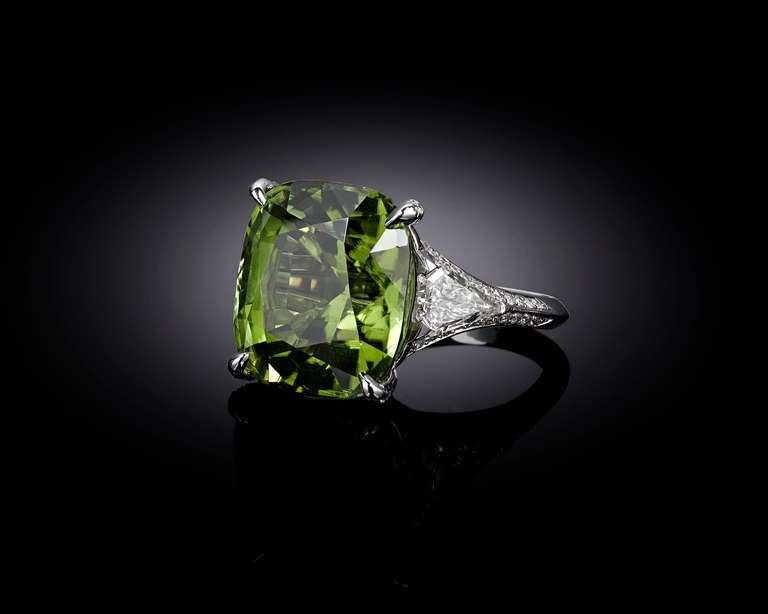 A mesmerizing 20.30-carat Burma peridot commands attention in this exquisite cocktail ring. Displaying the fresh, grass green hue for which peridots are so adored, this gem exhibits an uncanny clarity. Large peridot's such as this tend to contain
