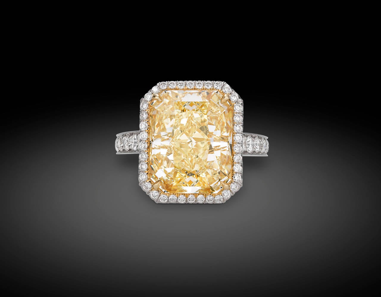 This mesmerizing 10.21-carat Fancy Yellow diamond displays a vivid hue rivaled only by the brilliance of the sun. Set in platinum and 18K yellow gold, the astounding modified brilliant-cut gem is certified by the Gemological Institute of America