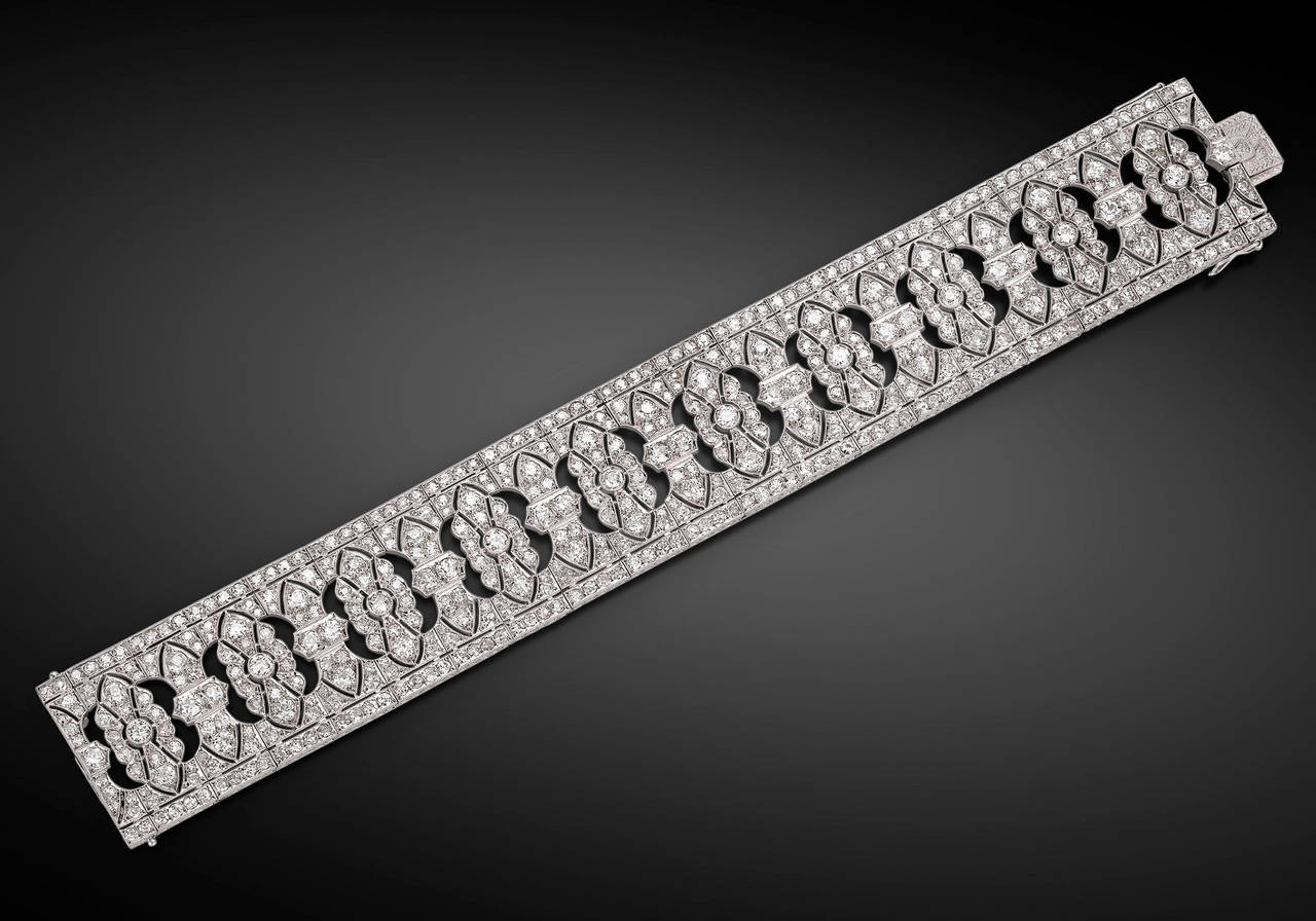 The classic beauty of the Art Deco era is on display in this stunning diamond bracelet. Boasting approximately 28.0 carats of exquisite diamonds in a sleek and feminine platinum design, this Italian-made bracelet is both chic and timeless. A bar