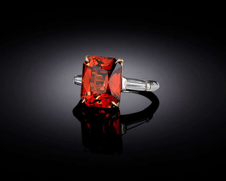 The radiance of the sunset shines from this rare Spessartite garnet. Displaying the opulent “mandarin” hue, this exceptional 8.06-carat stone is certified by the American Gemological Laboratories (AGL) as being completely unenhanced and natural. Set