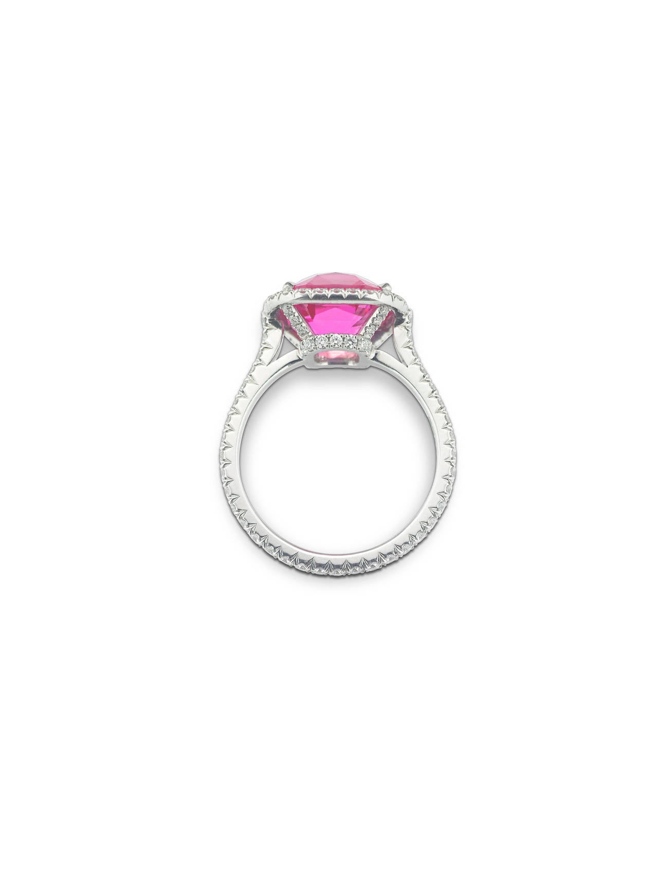 An absolutely enchanting and all natural cushion-cut pink sapphire rests among 0.78 glittering carats of micropave-set diamonds in this extraordinary ring. Boasting 4.88 carats and a magnificent rosy hue, this stone is a true beauty. Displaying