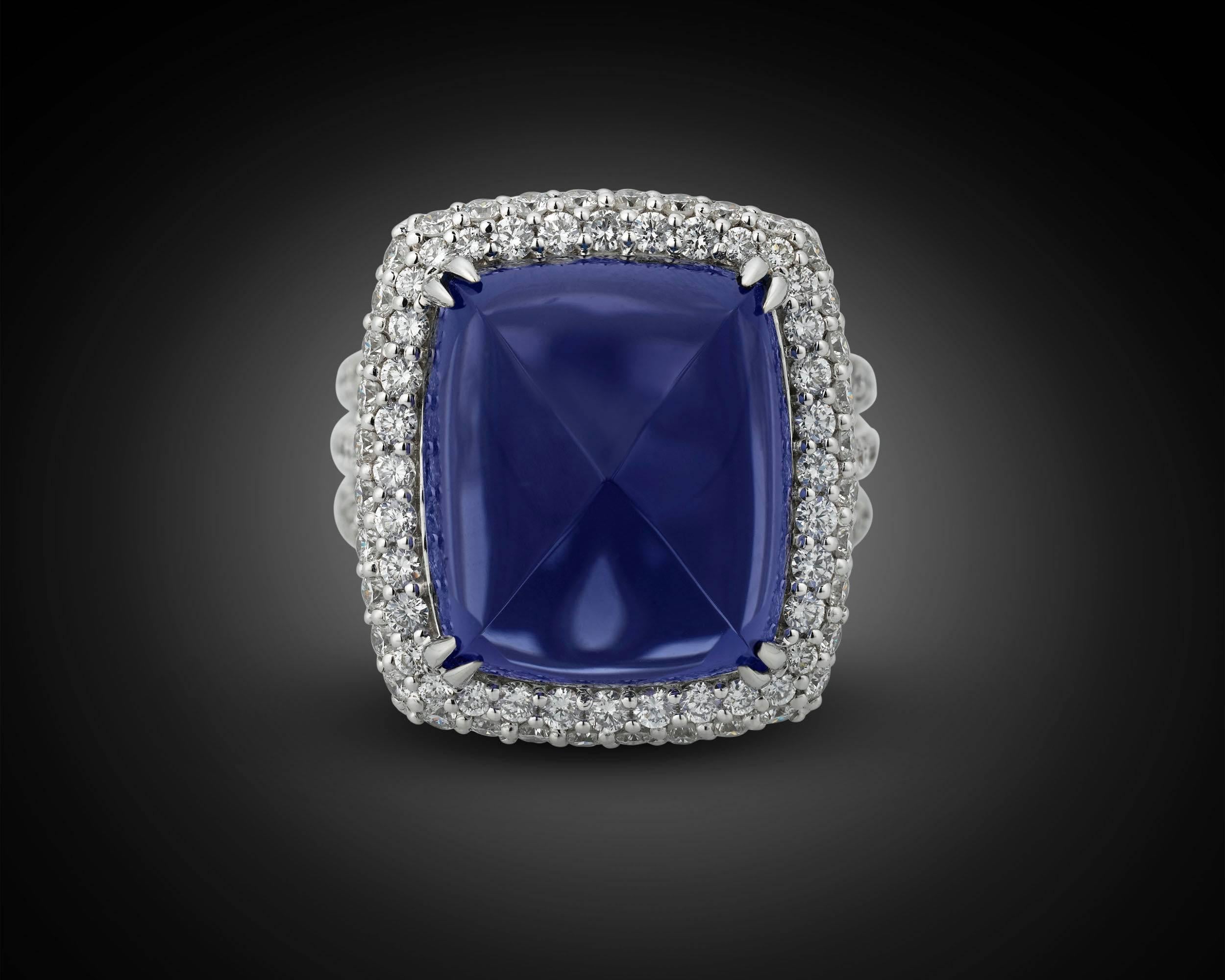 The striking and rare sugarloaf tanzanite in this breathtaking ring boasts the perfect, violetish-blue hue for which the best of these gems are so coveted. Weighing a striking 22.10 carats, this stone is perfectly complemented by 2.51 carats of