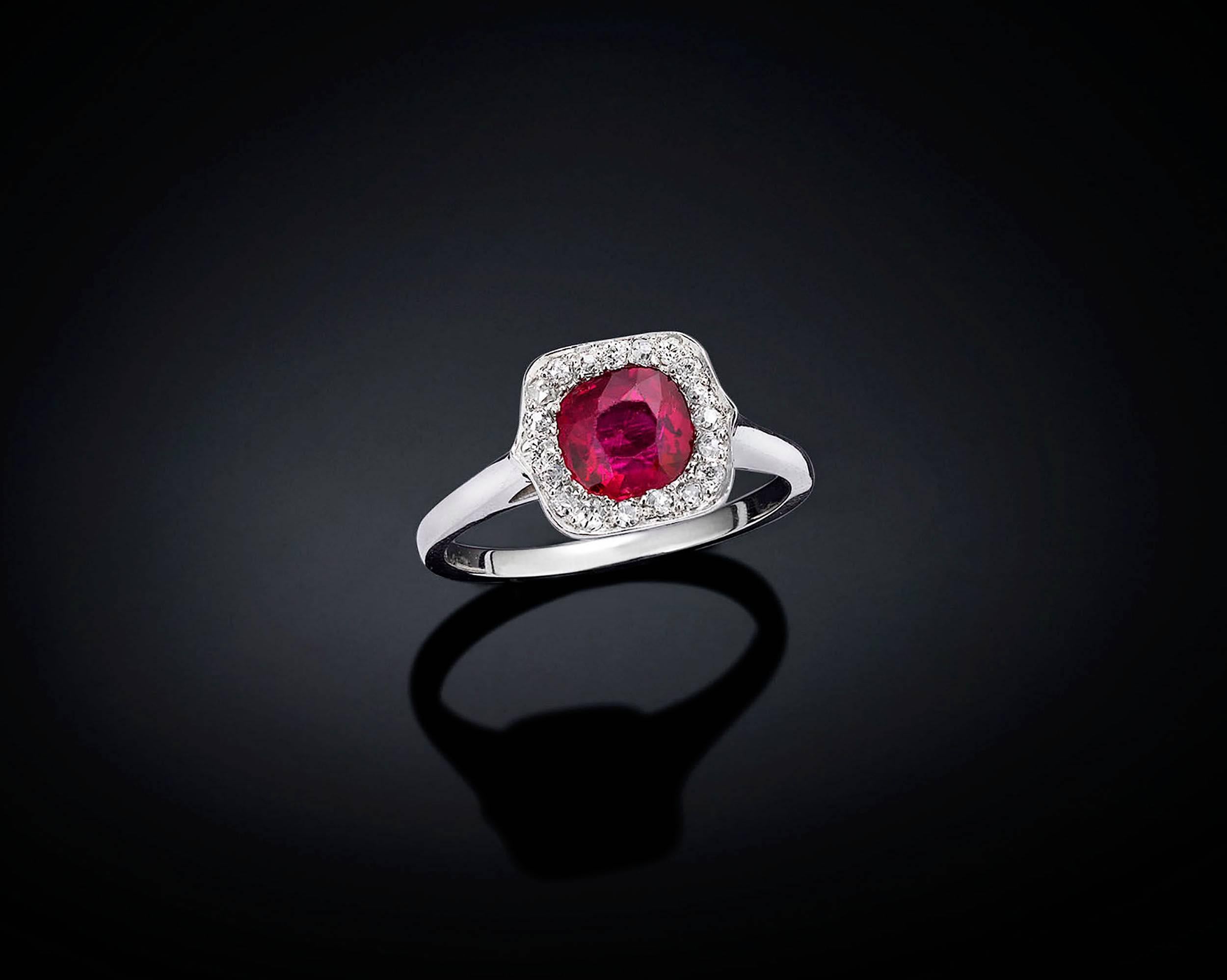 A lovely .81-carat untreated Burma ruby displays wonderful color in this stylish ring. Approximately .21 carats of white diamonds surround this crimson gem. The ruby is certified by the American Gemological Laboratories (AGL) to be of Burmese origin