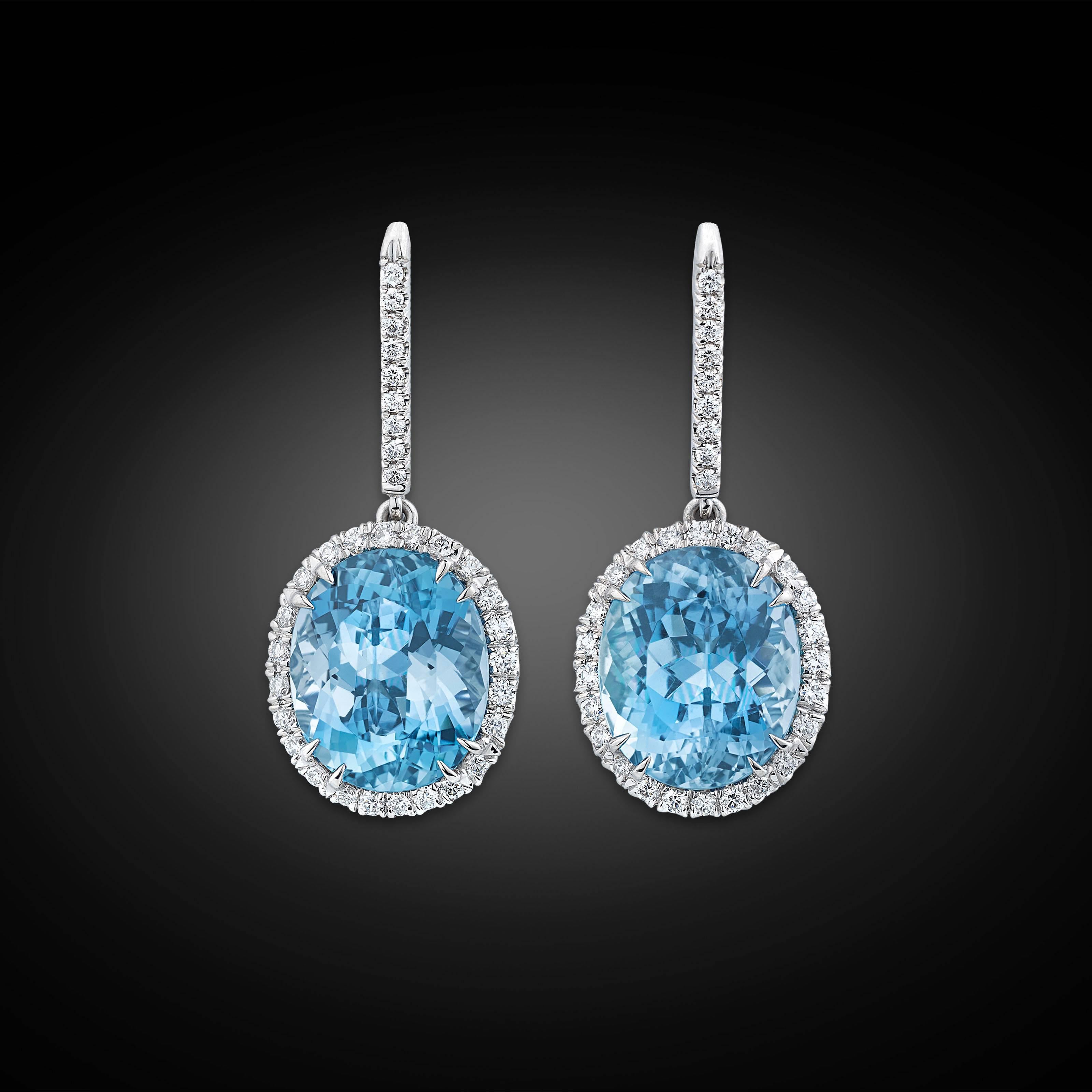 A pair of enchanting aquamarines dangle elegantly in these classic drop earrings. Weighing approximately 9.47 total carats, the perfectly matched gems display the crystal clear ocean-blue hue that make these exquisite stones so appealing. The lovely