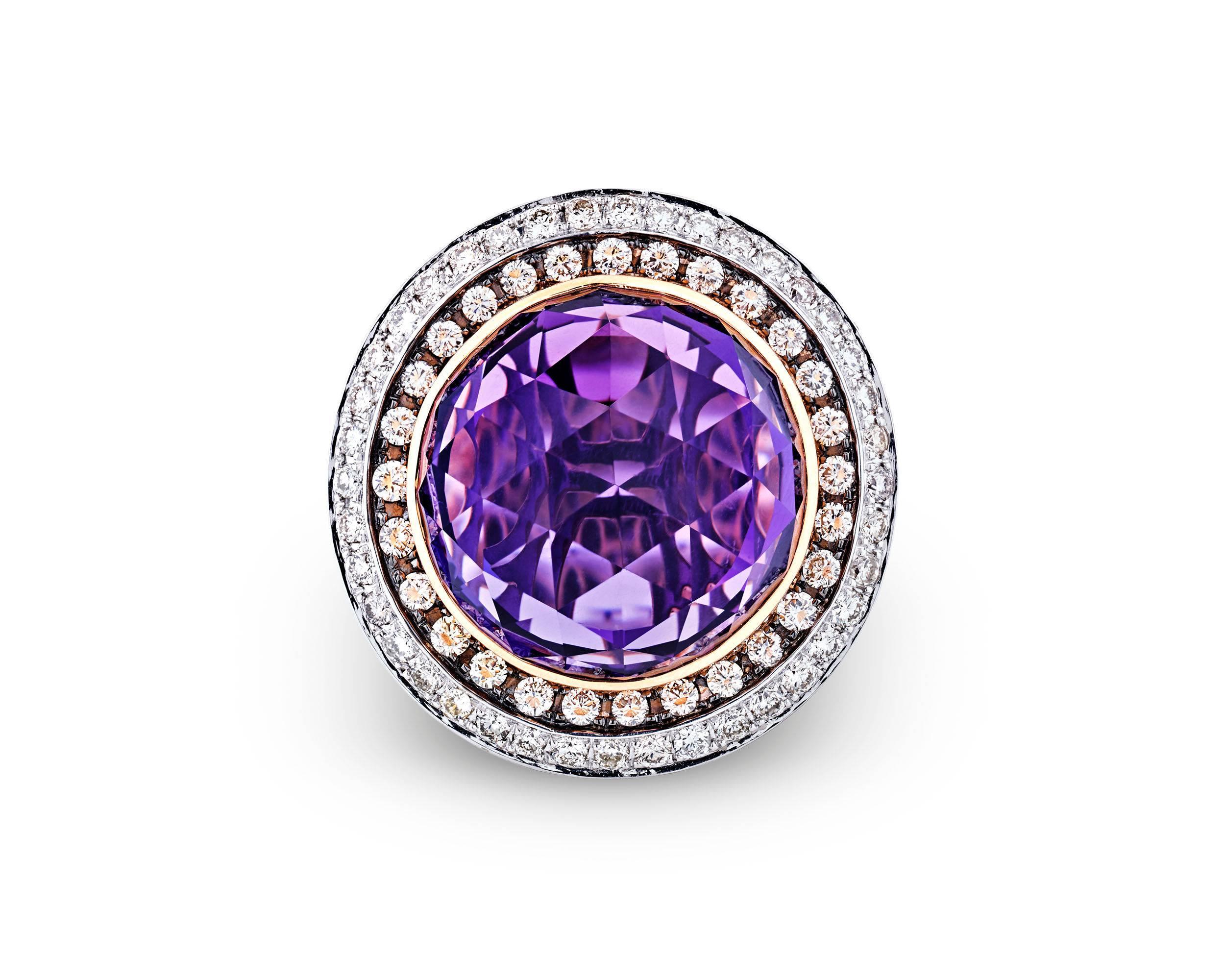 A mesmerizing amethyst weighing approximately 38.84 carats is the star of this spectacular cocktail ring. Beautifully cut to accentuate its stunning purplish pink hue, this monumental jewel is surrounded by a sea of glistening colored diamonds.