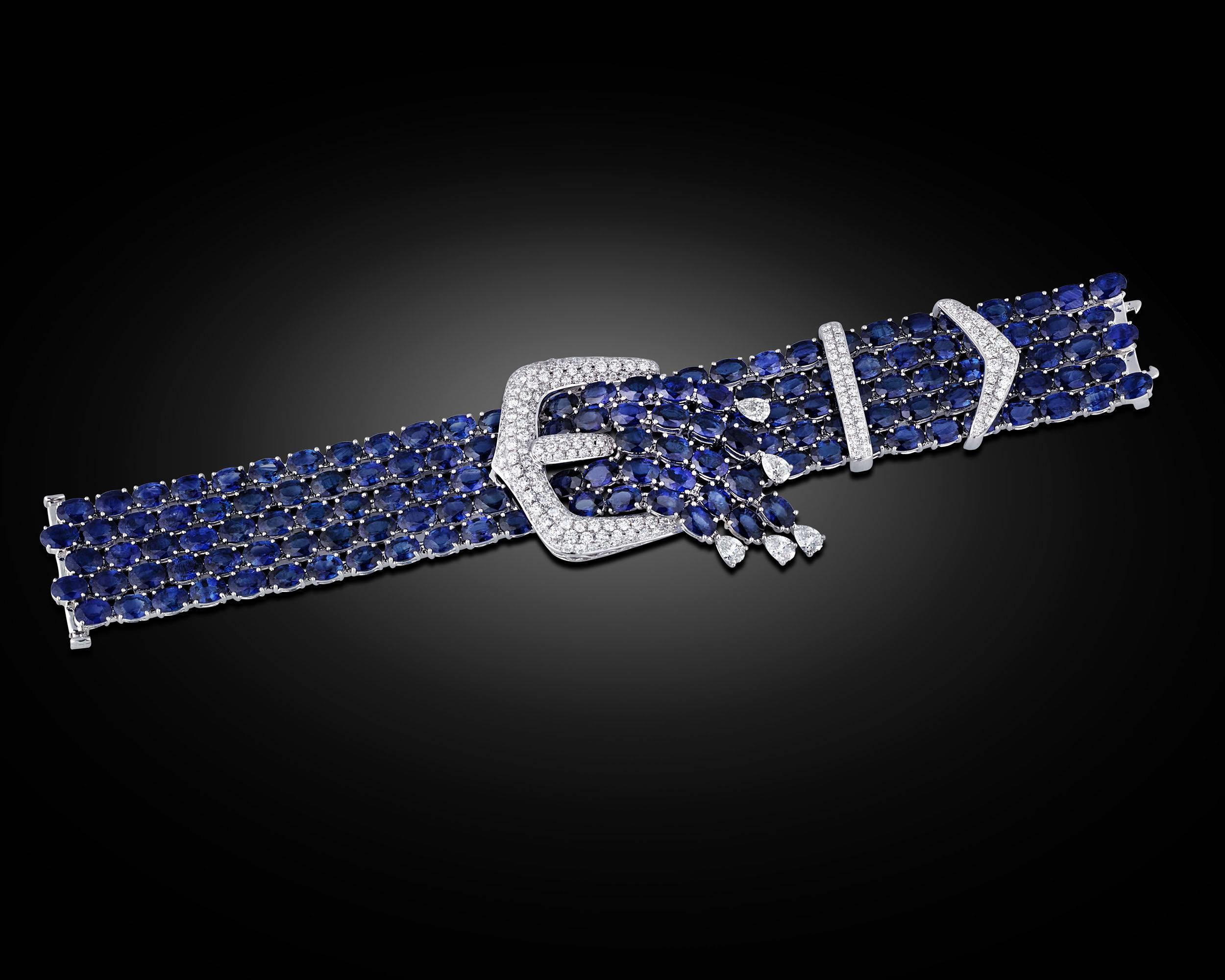 Bold and sophisticated, this extraordinary bracelet features five dazzling rows of cabochon sapphires in a creative, yet elegant design. Totaling 86.92 carats, the enchanting jewels are joined by sparkling diamond buckle accents to create a uniquely