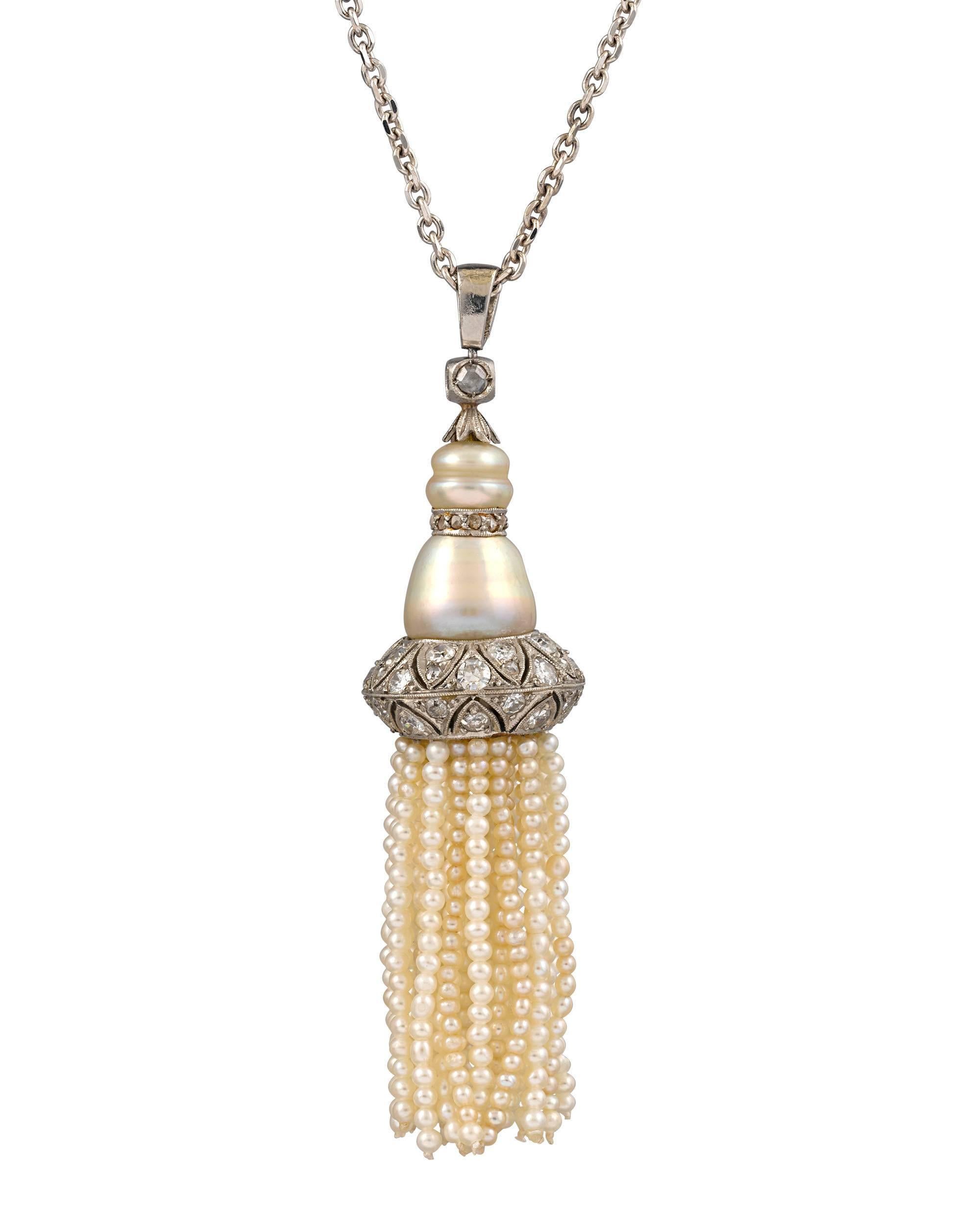 This elegant Art Deco sautoir, or tassel necklace, epitomizes femininity and timeless style. Exquisite strands of natural pearls dangle from the pearl pendant, which is encrusted with white diamonds for the perfect amount of sparkle. Bold with a