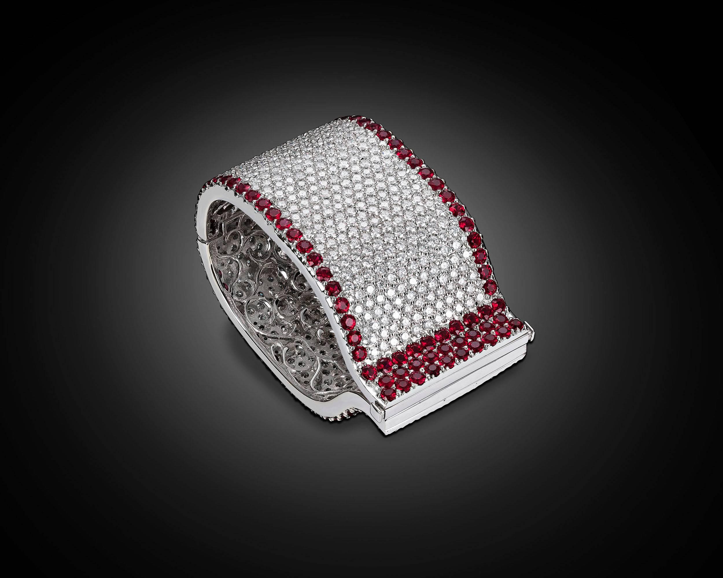 This stunning diamond and ruby cuff bracelet makes a bold statement. Laden with approximately 59.00 total carats of beautifully matched white diamonds, the extraordinary cuff is bordered by approximately 40.00 total carats of luxurious Burma rubies.