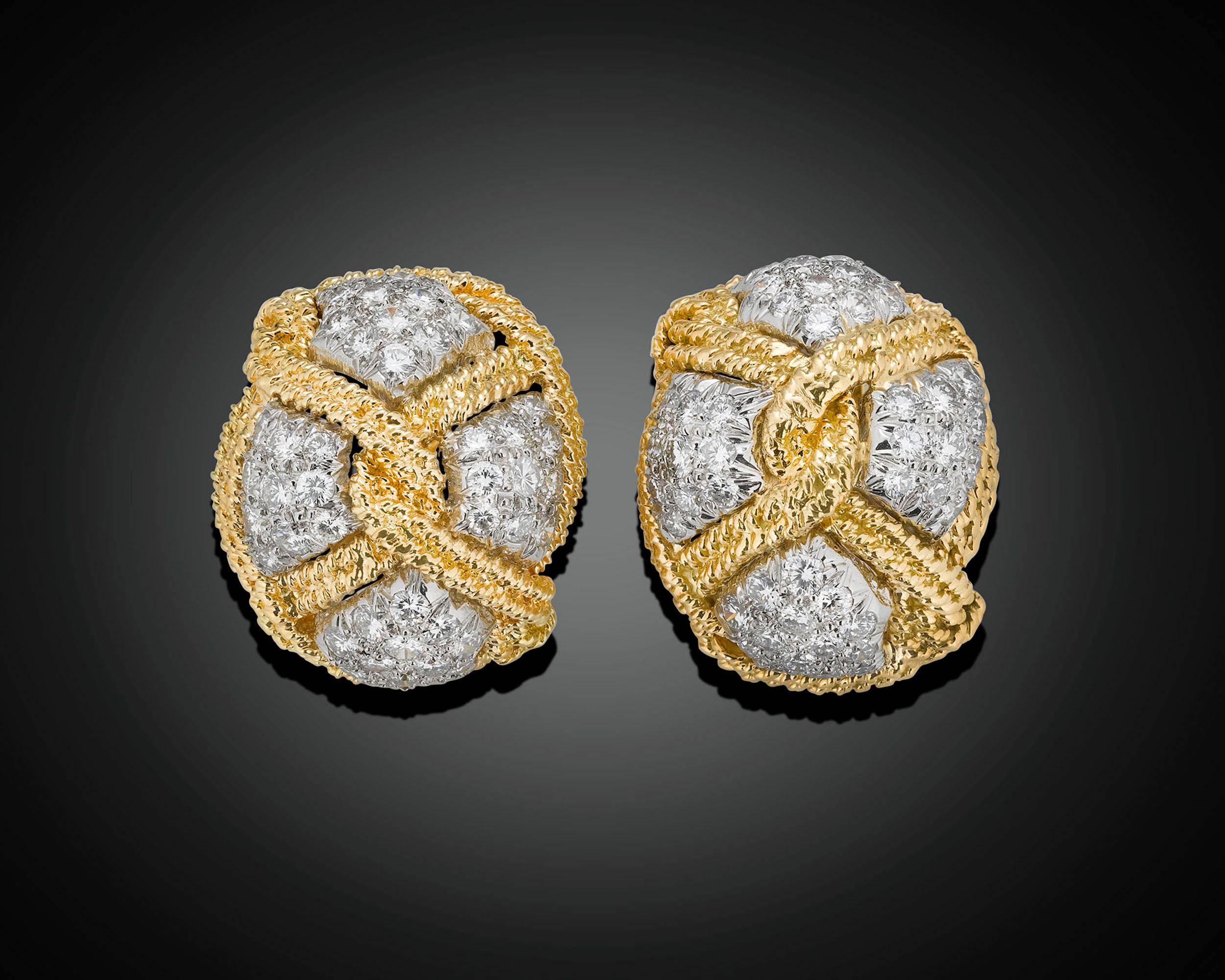 This elegant pair of earrings by David Webb boasts a unique and stylish twisted knot motif crafted of 18k yellow gold and platinum. Approximately 2.88 total carats of glistening white diamonds add exceptional sparkle to the structural design.