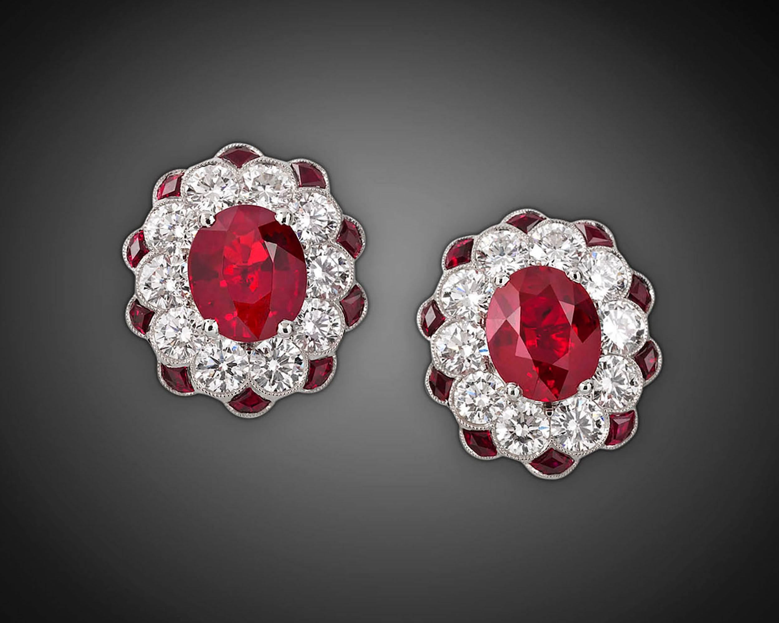 Stunning pigeon-blood red Burma rubies weighing a combined 2.64 carats dazzle in these timelessly classic earrings. The rare, richly colored jewels are accompanied by 1.60 total carats of white diamonds that add exceptional brilliance to the