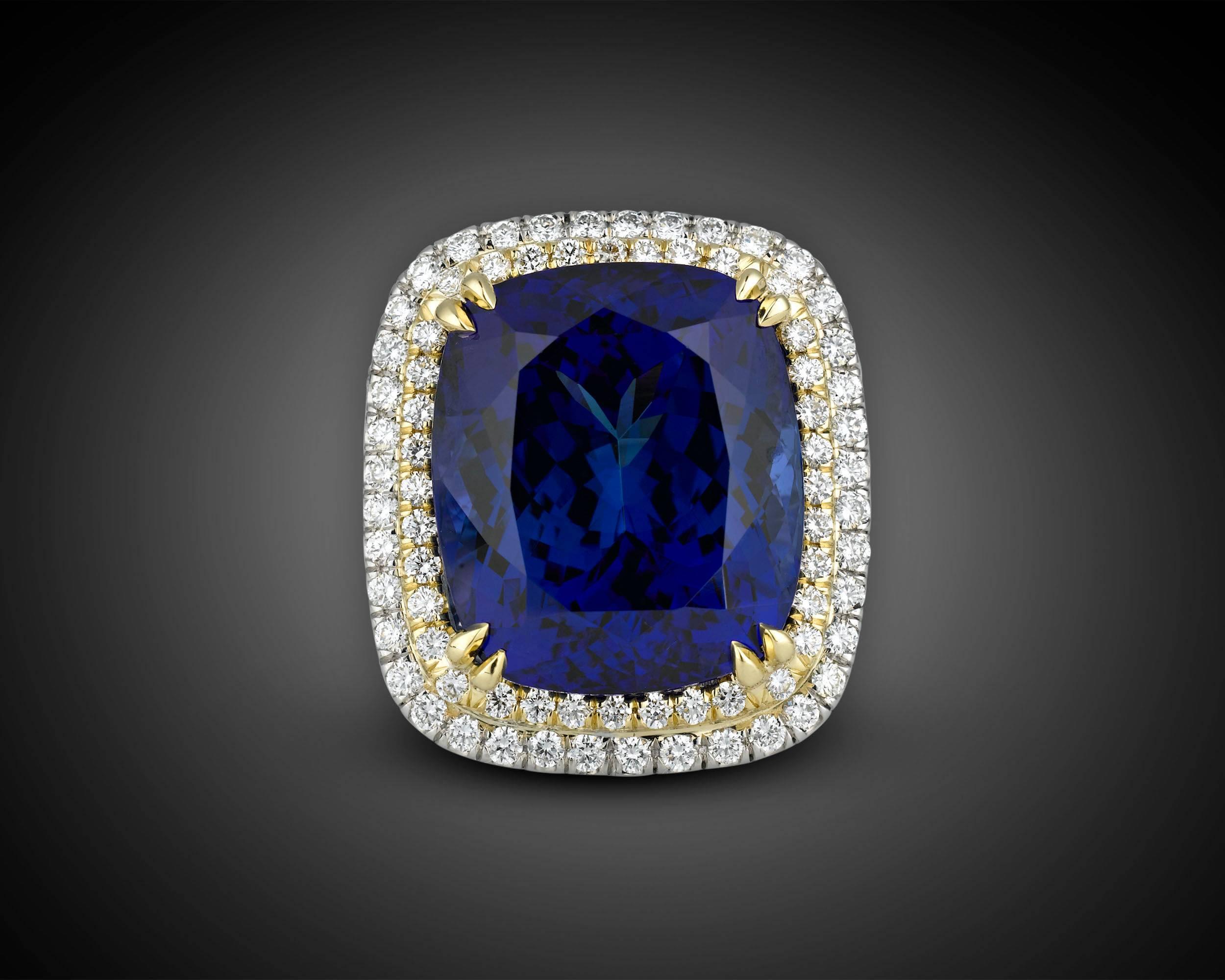 An opulent and rare 22.98-carat tanzanite is the star of this stunning ring. Displaying the incredible deep violetish-blue hue for which tanzanites are so desired, this striking gemstone's flawless cushion shape showcases its brilliant, natural