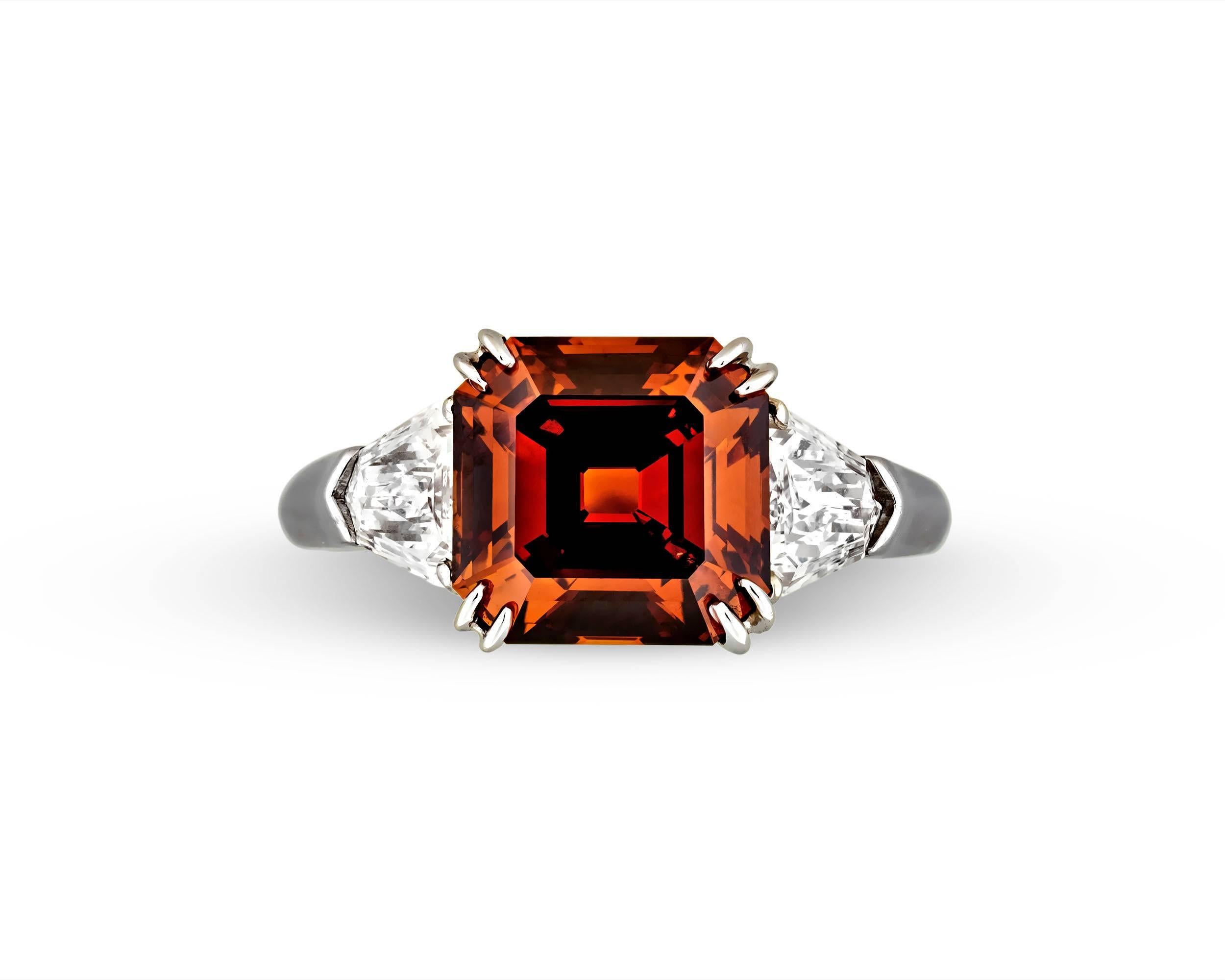The sumptuous 3.38-carat fancy deep brown orange diamond in this eye-catching ring blazes with an impeccable, fiery orange hue. Referred to as 