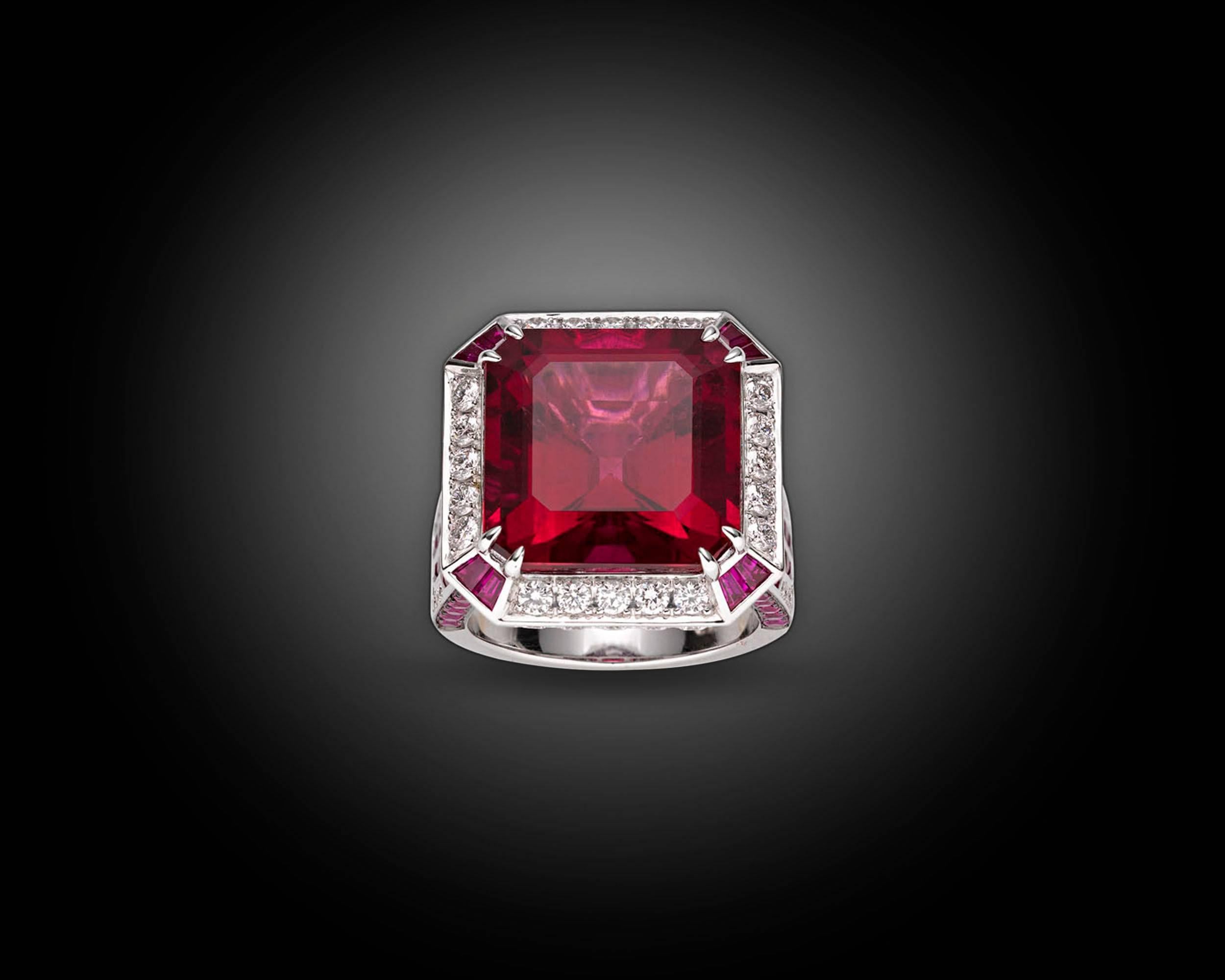 Exuding all of the glamour of the Art Deco era, this striking cocktail ring boasts a stunning rubellite tourmaline at its center. Weighing a breathtaking 16.12 carats, the striking gemstone displays a deeply saturated, rich crimson hue that is