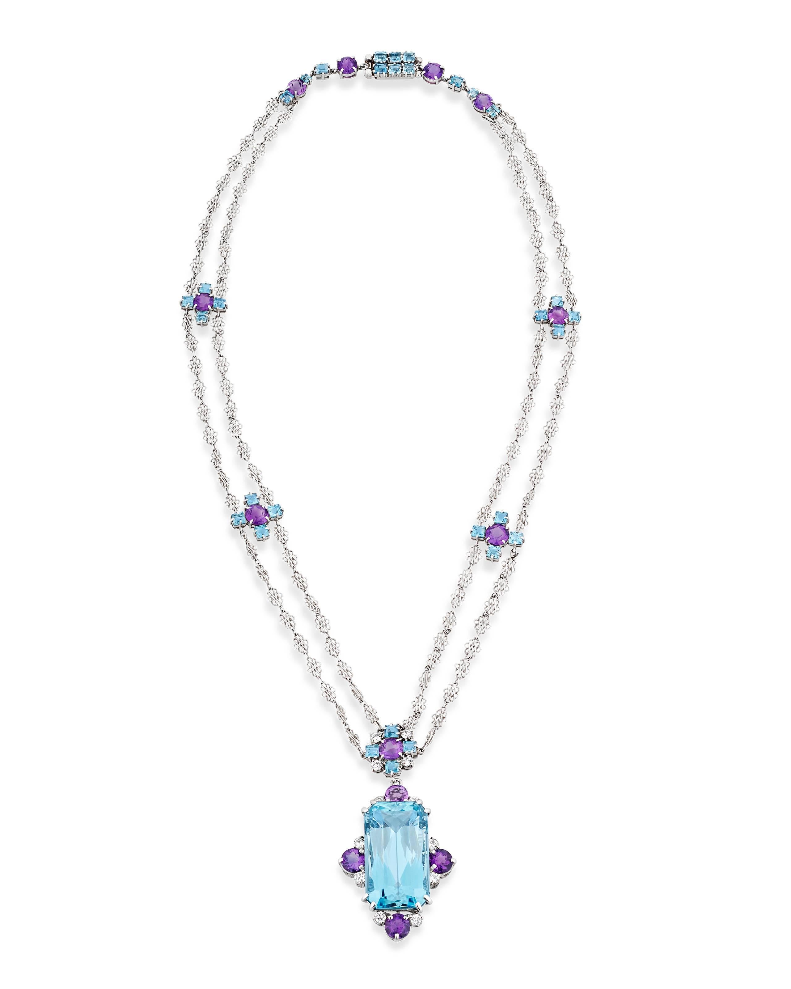 Crafted by the legendary Tiffany Studios and retailed by Tiffany & Co., this extraordinary aquamarine and amethyst necklace is a rare and unique masterpiece of jewelry design. A large faceted aquamarine weighing approximately 12.00 carats is the