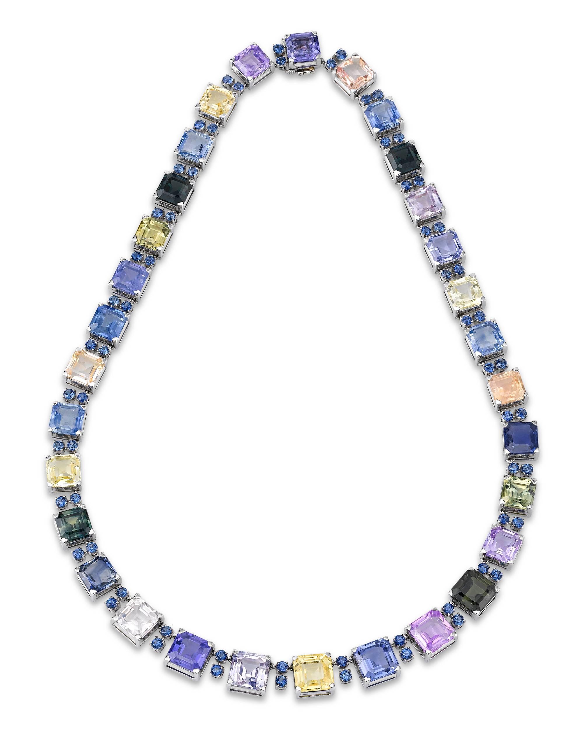 This extraordinary multi-color sapphire necklace is the work of the legendary jewelry designer Oscar Heyman. The dazzling strand showcases 115.72 total carats of spectacular sapphires that exhibit a delightful array of hues, from brilliant yellow,
