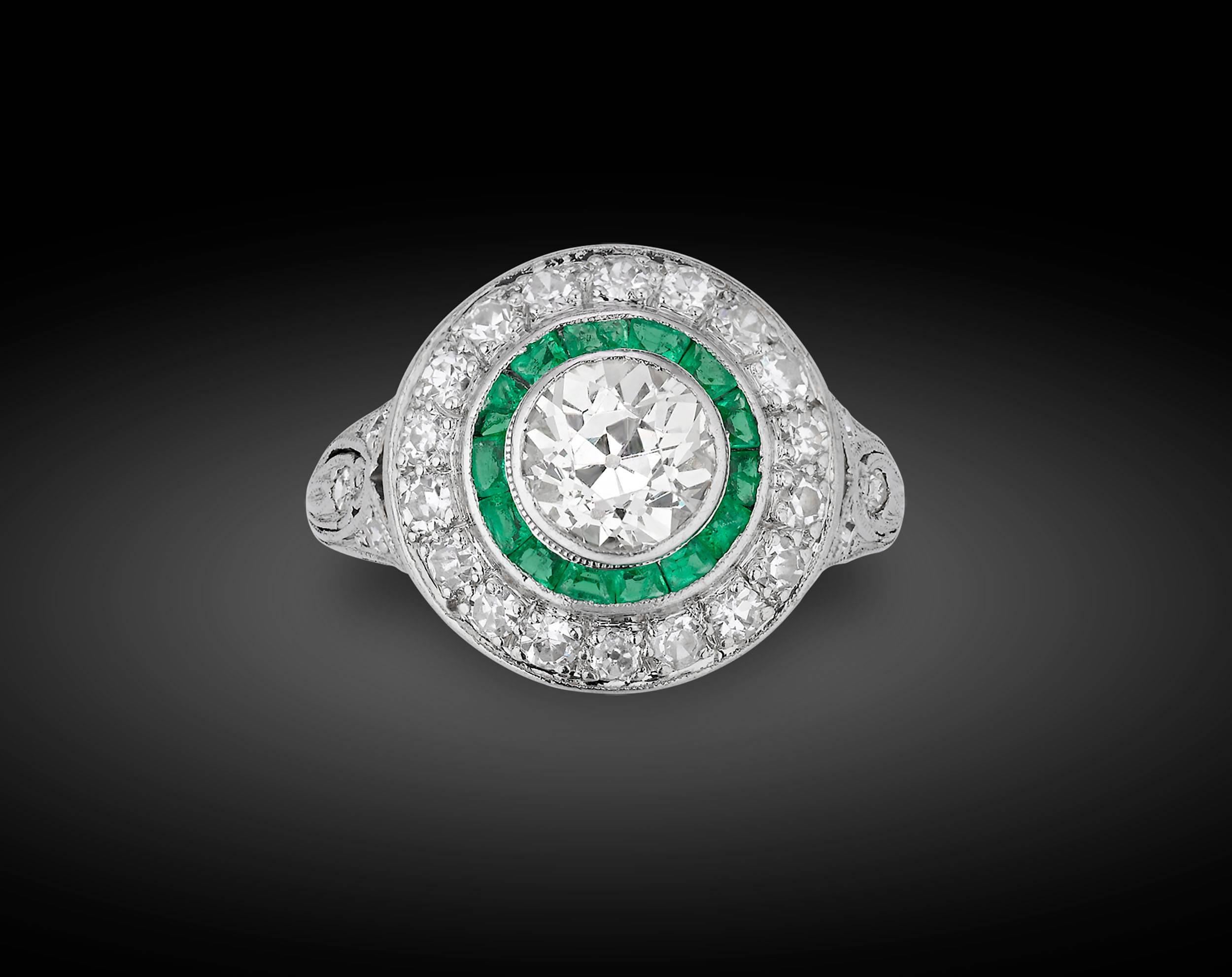 Bold and chic, this contemporary Art Deco-style ring is a symphony of diamonds and emeralds. Crafted in a striking 