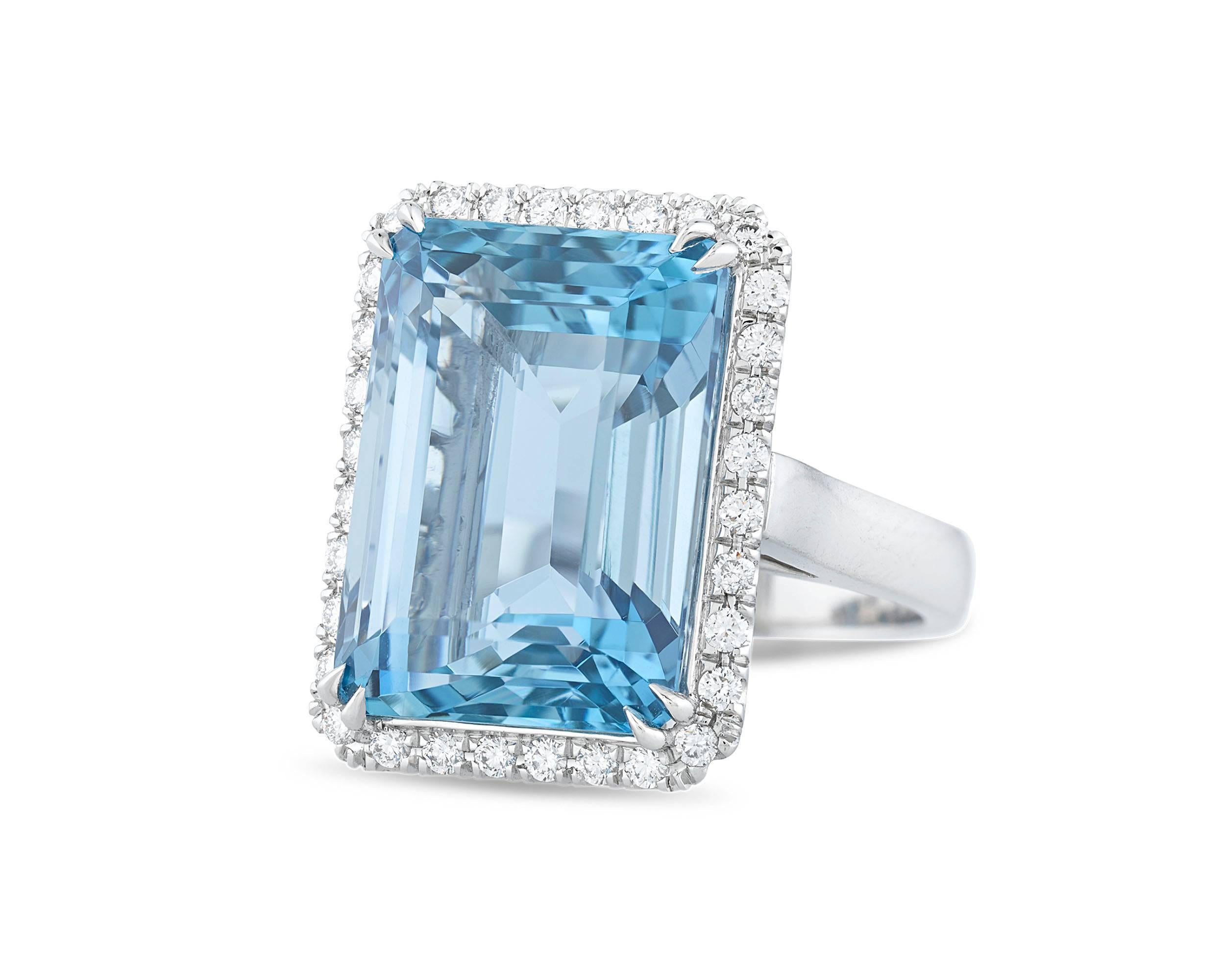 The emerald cut of this incredible 19.44-carat aquamarine is the perfect means by which to showcase this gemstone's marvelous clarity and color. Surrounded by 32 shimmering white diamonds weighing 0.47 carats, this jewel possesses the optimal