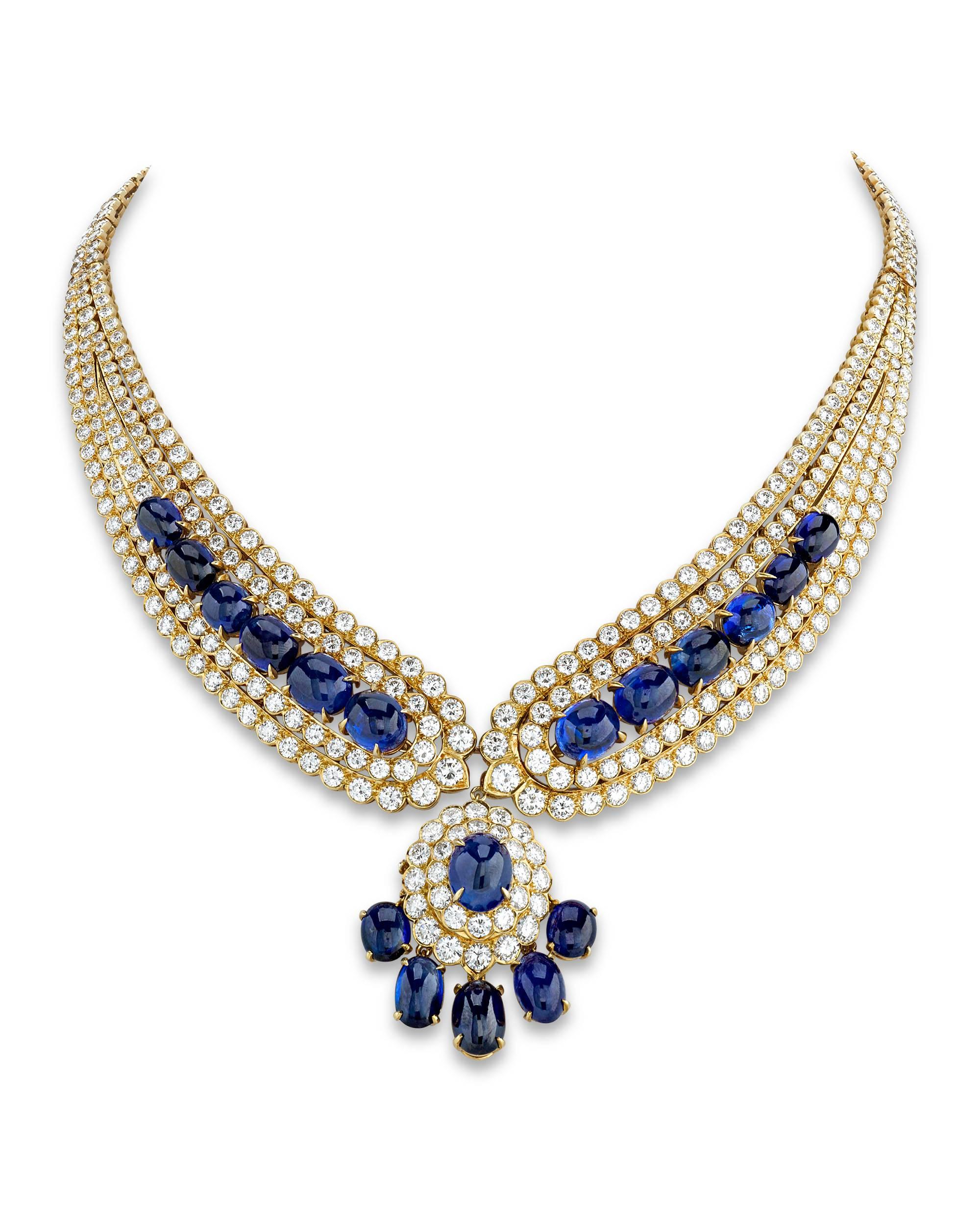 This captivating Van Cleef & Arpels necklace and earring suite don approximately 92.40 carats of deep blue cabochon sapphires. The vibrant jewels are joined by approximately 44.25 carats of glistening white diamonds. Signed. 18K gold.

16” length 