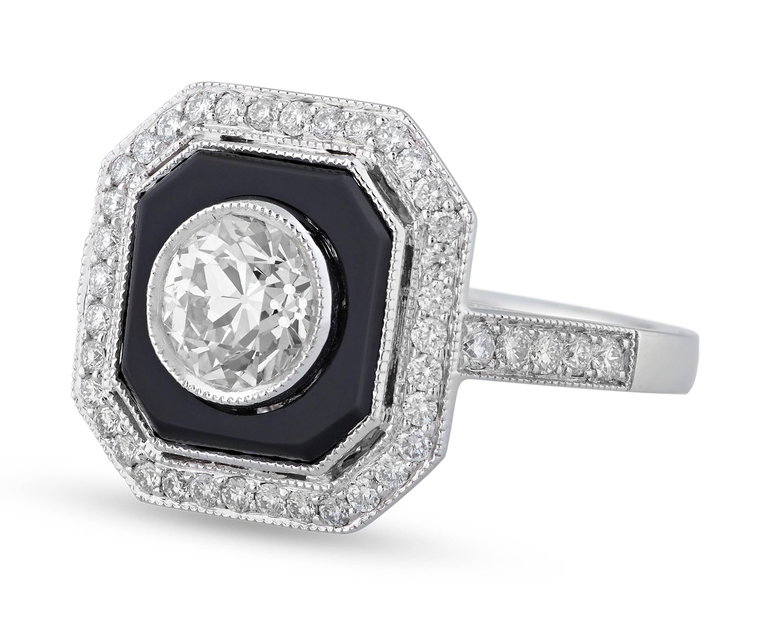 The timeless style of the Jazz Age comes to life in this eye-catching Art Deco-style ring. Onyx totaling 0.39 carat surrounds the brilliant 0.88-carat round diamond at the ring’s center. Additional white diamonds add further sparkle to the geometric
