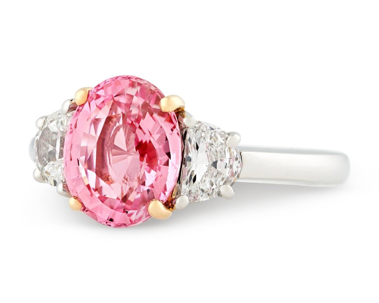 This exquisite ring features a stunning Padparadscha sapphire, the rarest of all sapphires. Weighing 3.07 carats, this jewel displays the superb pinkish-orange color that makes these stones so highly coveted. The sapphire is certified by the