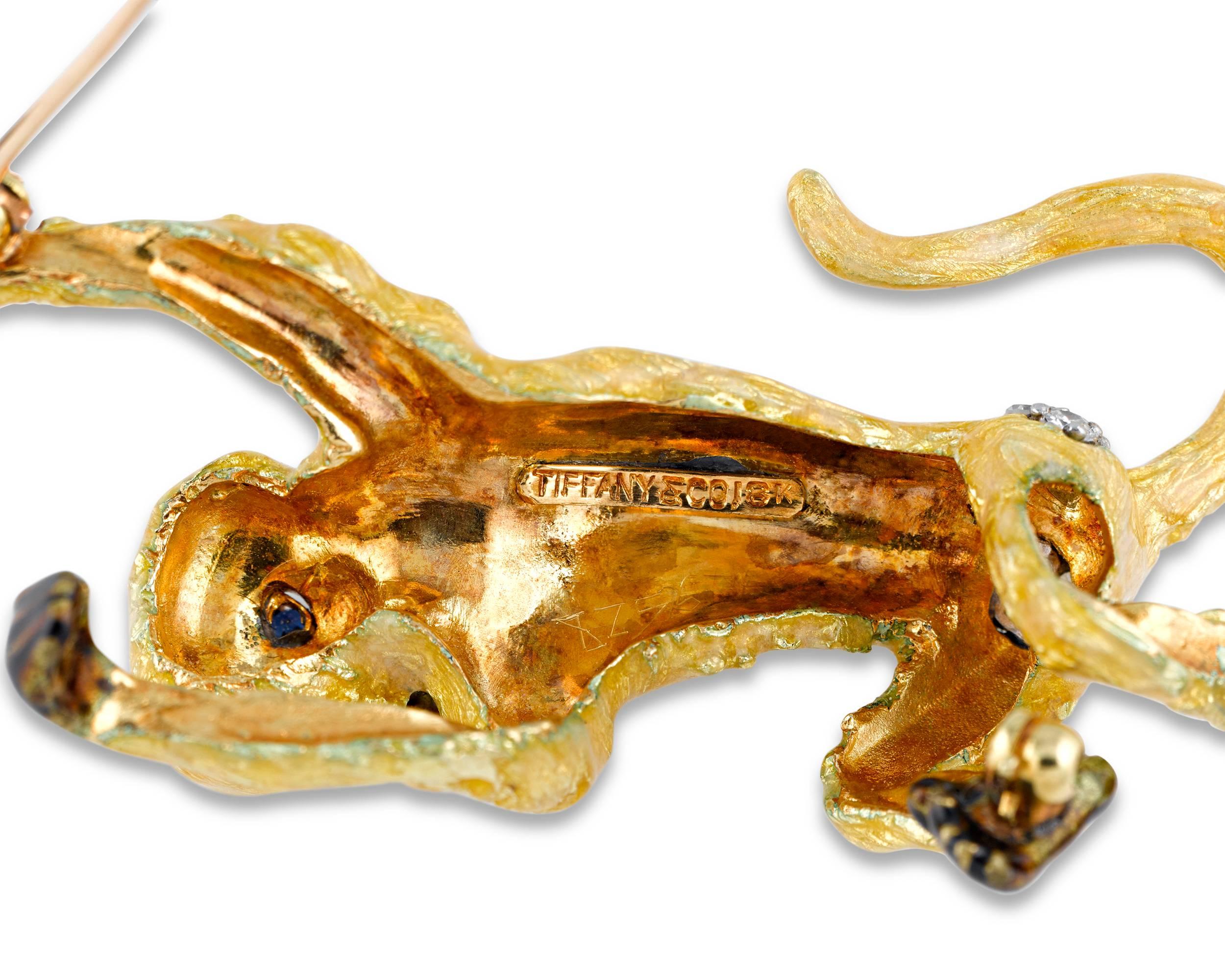 With twinkling sapphire eyes and diamond-accented haunches, this incredibly detailed rhesus monkey brooch was created by Tiffany & Co. Crafted of exquisitely worked 18K yellow gold, the body of this playful primate is covered in translucent gold