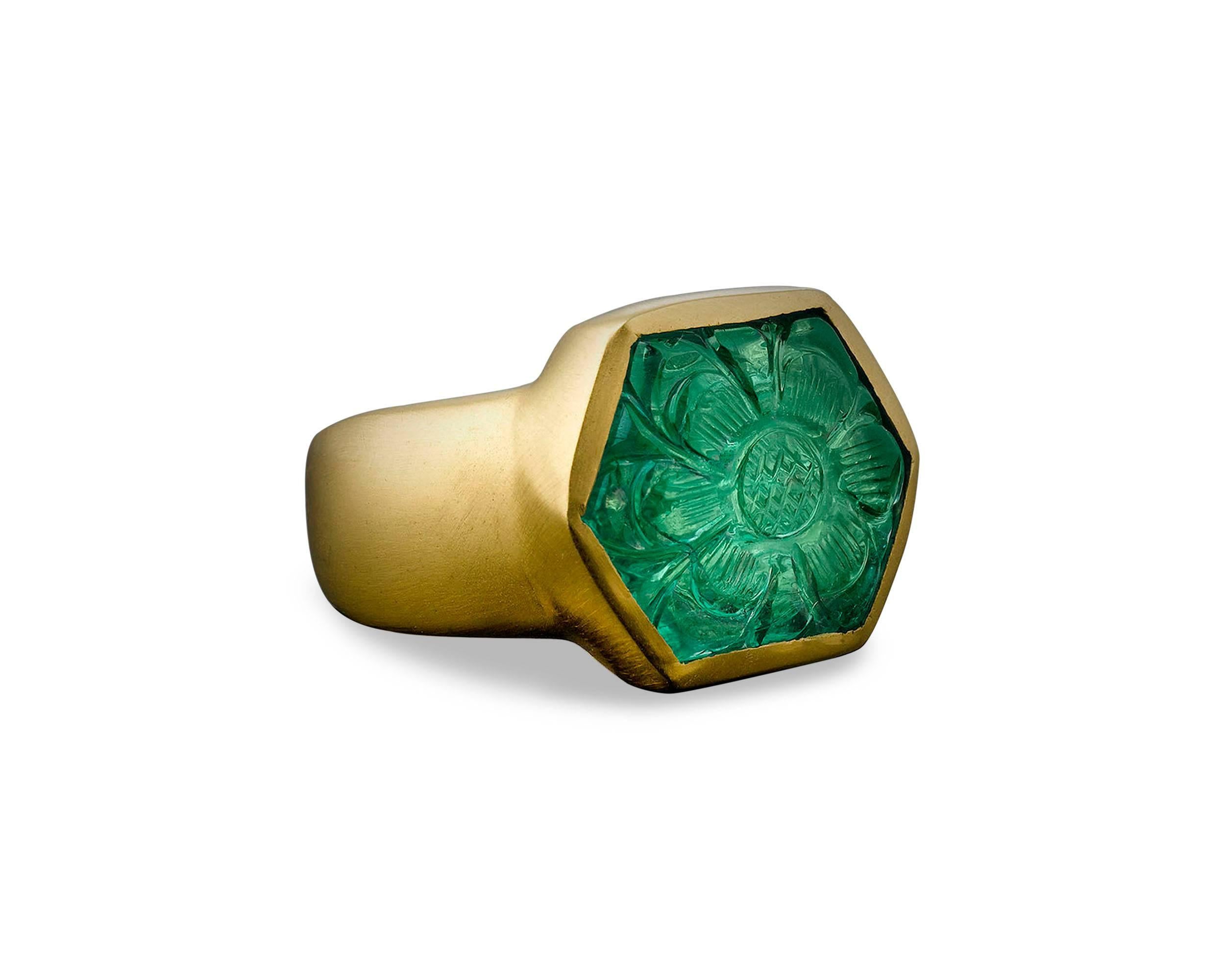 Carved in a rich floral design in the Mughal taste, this brilliant 11.85-carat Colombian emerald displays incredible transparency and color. This vibrant gem is bezel set in 22K yellow gold. This emerald’s flowery motif is consistent with those used