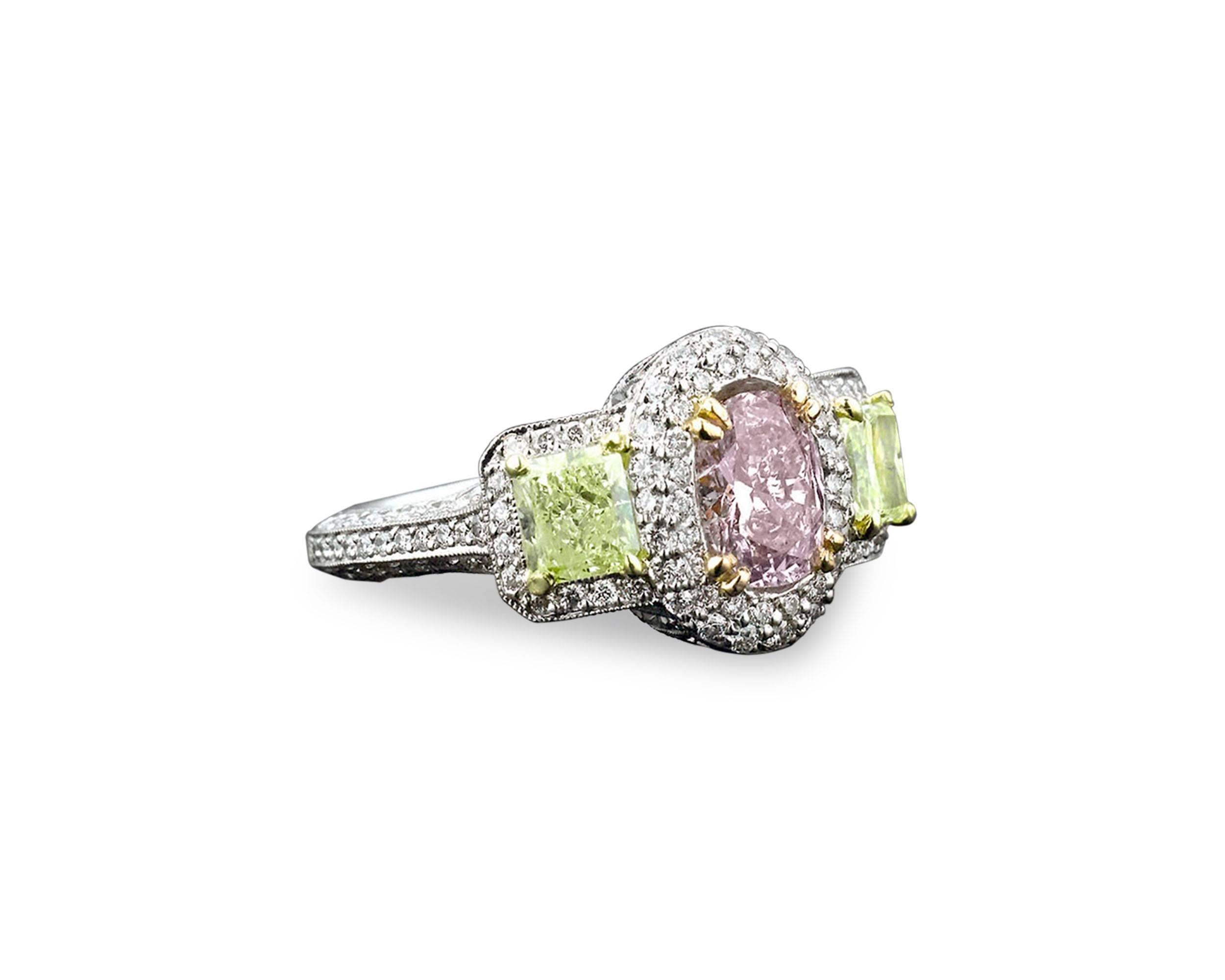 Colored diamonds are the rarest and most exquisite of nature's treasures. This ring showcases not one, but three natural fancy colored diamonds of brilliant color and shimmer. The center diamond is a stunning 1.08-carat pinkish-purple diamond, with