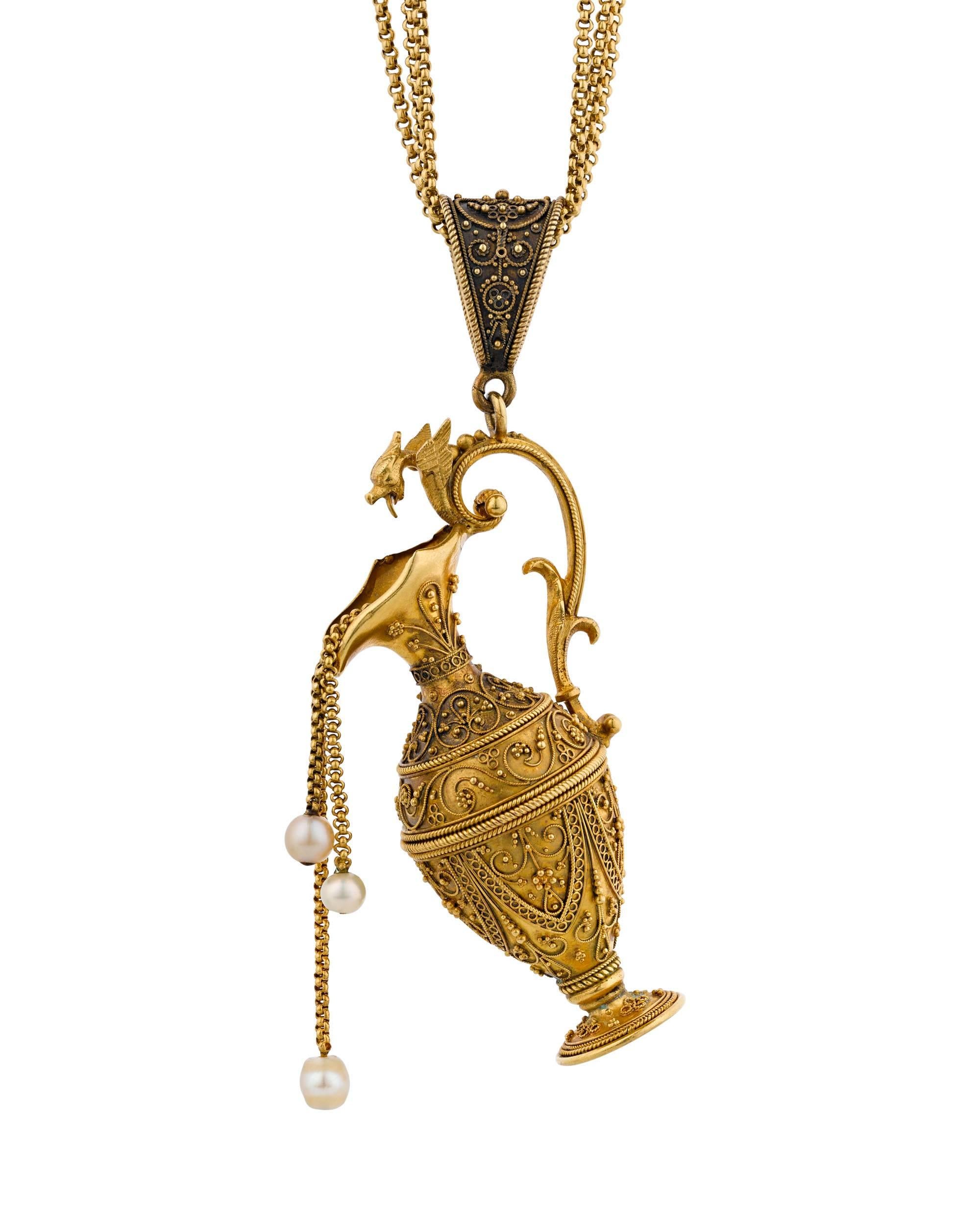This extraordinary Victorian pendant necklace is an elegant and dramatic example of the Etruscan Revival style. The exquisite 21-22k gold pendant takes the shape of a neoclassical ewer, which has been decorated through an ancient process known as