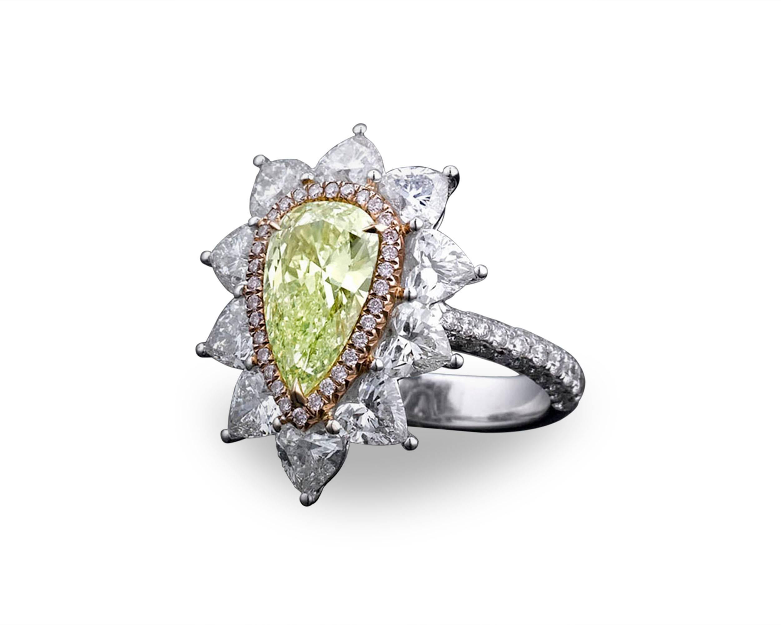 A superb 1.72-carat natural fancy intense yellow-green pear shaped diamond shines in this classic ring crafted of 18K white gold. Ten fiery white pyramid-shaped carat diamonds, weighing 2.48 total carats, beautifully accentuate the rare radiant-cut