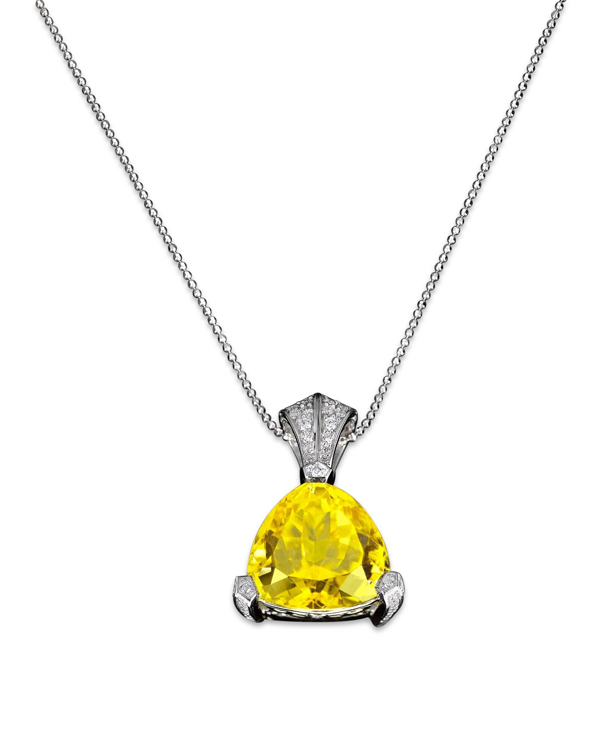 An incredibly rare yellow tourmaline shines with all the brilliance of the sun in this stunning pendant. Weighing an astounding 14.76 carats, this trilliant-cut gem is set with 0.50 carats of white diamonds in its platinum setting.

One of the