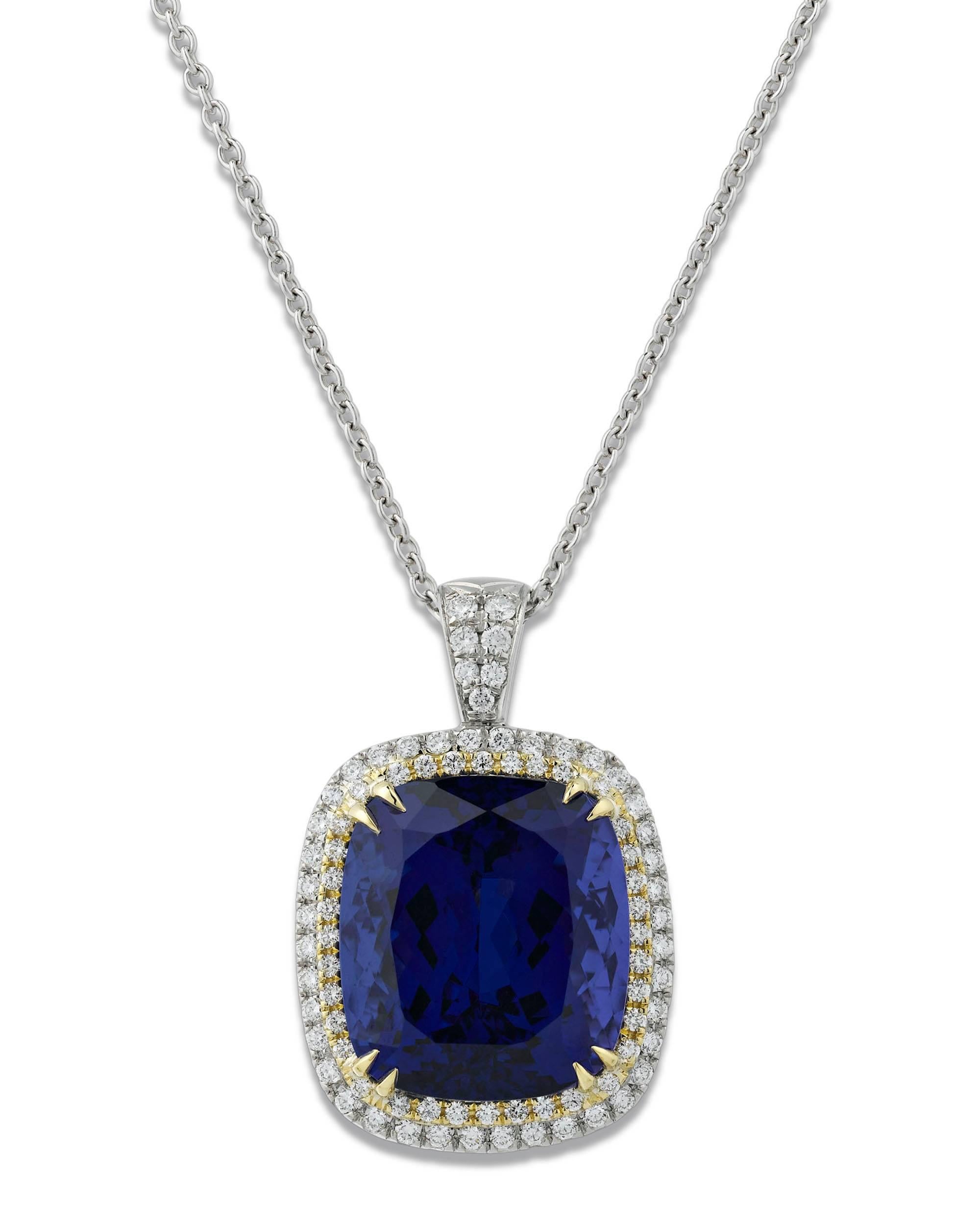 This extraordinary, untreated 24.16-carat tanzanite is truly an extraordinary gemstone. Encircled by 0.99 total carats of shimmering white diamonds, this brilliant cushion-cut gem exhibits the rich violetish-blue color for which these stones are