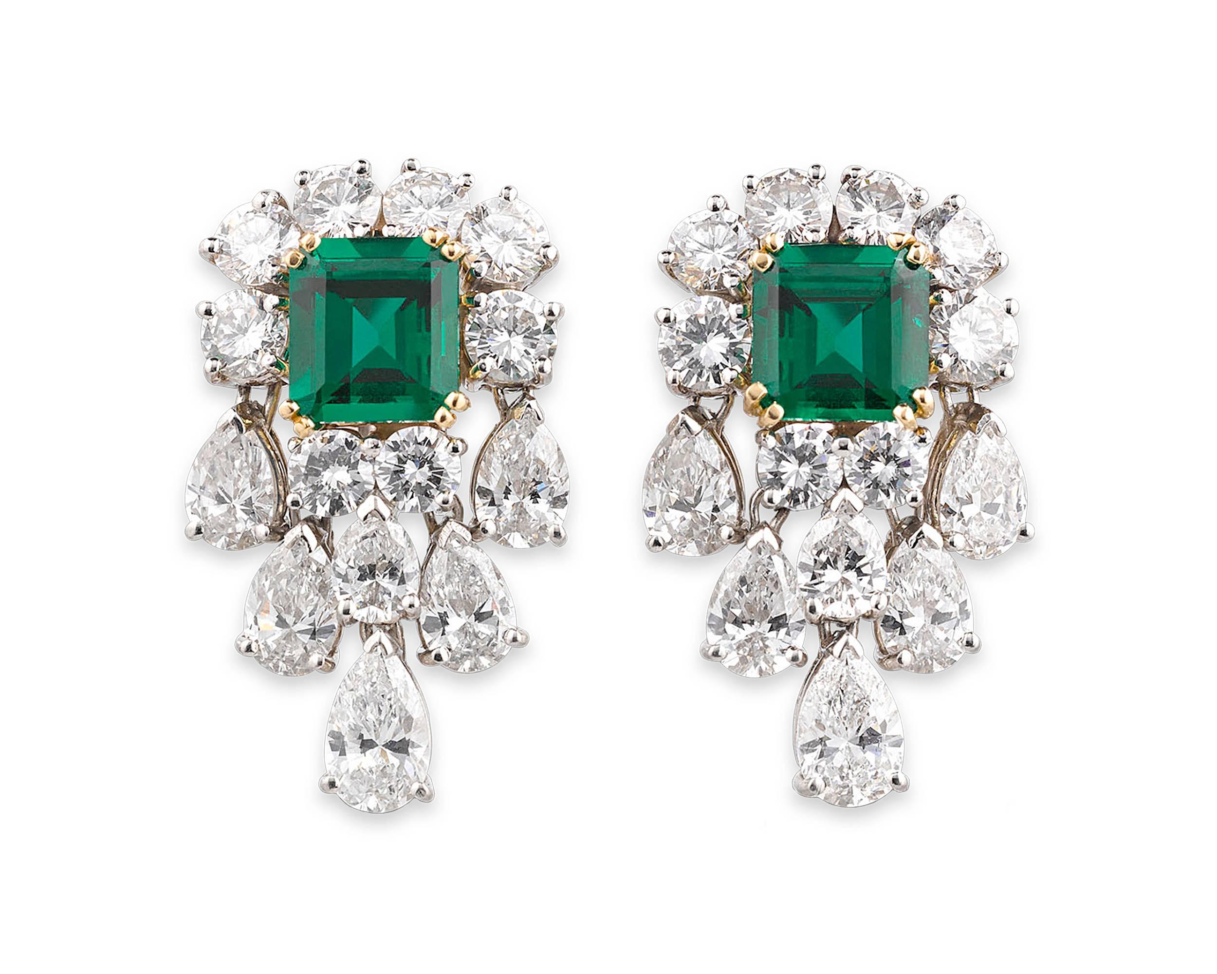 This stunning and dramatic pair of chandelier earrings encase two Old Mine emeralds of extraordinary color and clarity. Certified by the American Gemological Laboratories as being no oil and untreated, the stunning duo total 3.12 carats and claim an