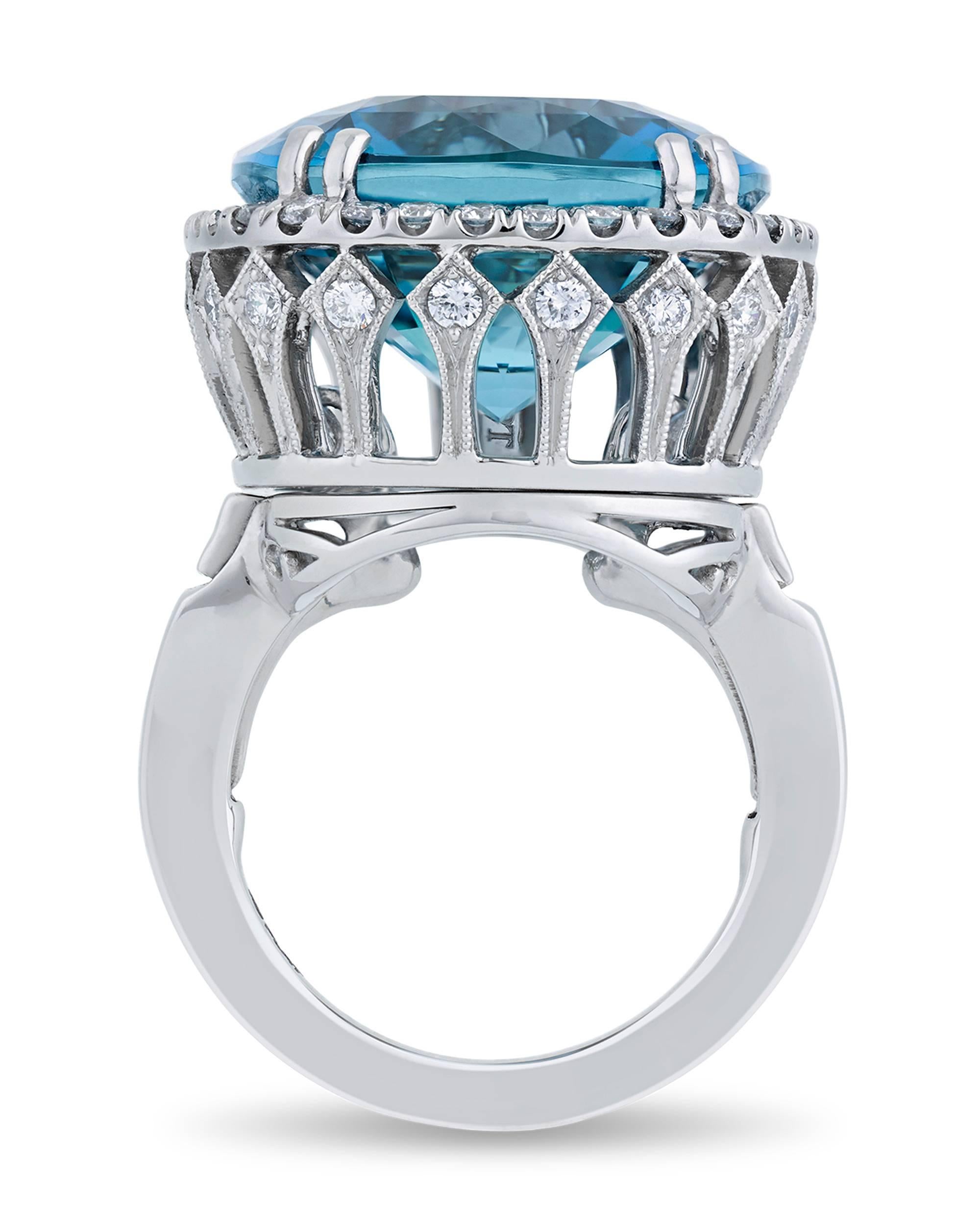 The incredible 22.22-carat aquamarine set in this ring captures attention with its vibrant aqua color. The cushion-cut gemstone possesses the deeply saturated Santa Maria blue hue that is found only in the rarest variety of these stones. Named in