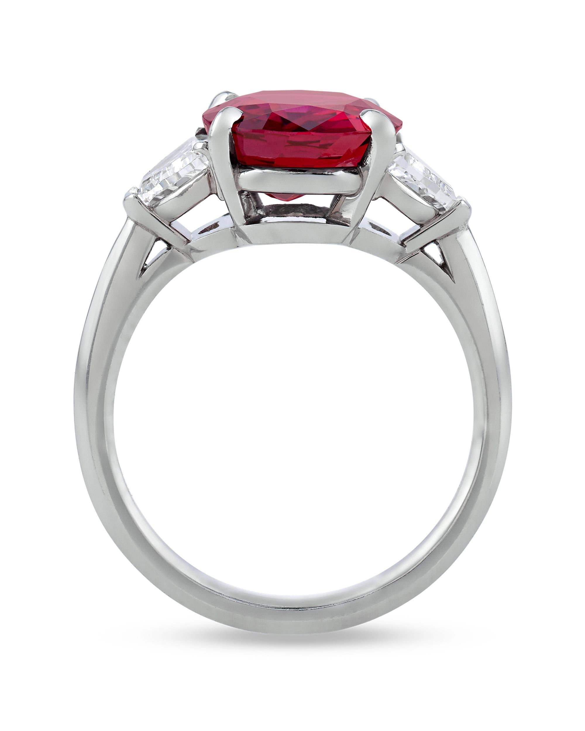 Weighing 4.28 carats and certified to be untreated is the exquisite and scarce Burma ruby set within this elegant three-stone ring. Gübelin Gem Lab has certified this brilliant jewel to be of Burmese origin and to be free of any indications of heat