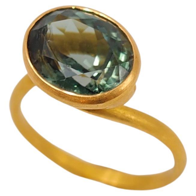 This delicate ring by Scrives is composed of a deep green tourmaline of 5.05cts. 
The stone exhibit natural and typical inclusions. 
This design allows light to come into the stone from multiple directions and put into highlight the stone. This ring