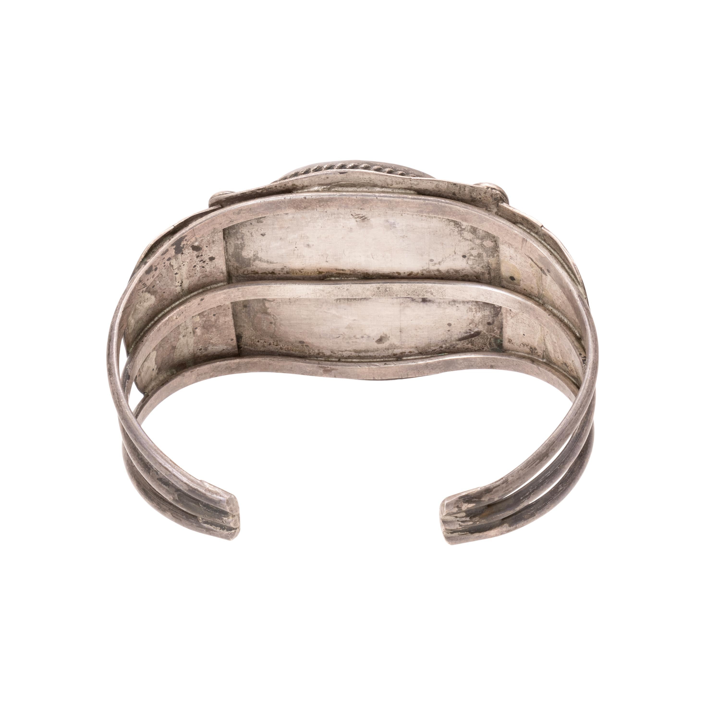 Turquoise and sterling silver cuff bracelet. Large Blue Gem turquoise stone framed by intricate stamped sterling and twisted rope border. Unmarked. Old Pawn. From the Indian Store in Clovis, New Mexico. Size: 5 3/4