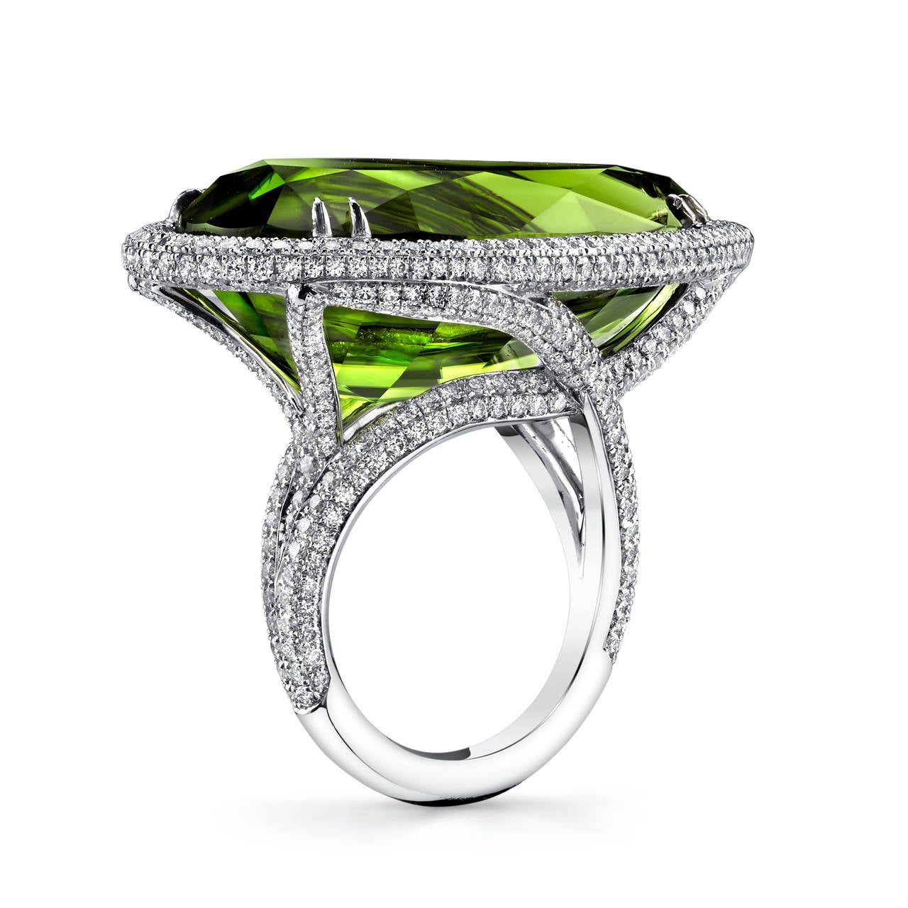 Pear Shaped Pakistani Peridot set in 18 Karat White Gold, accented with Micro Pave Ideal Cut White Diamonds. GIA Certified Center Stone with a Total Weight of 44.30CT. White Diamond Quality G/VS2 with a Total Weight of 4CT. 

Peridot’s color