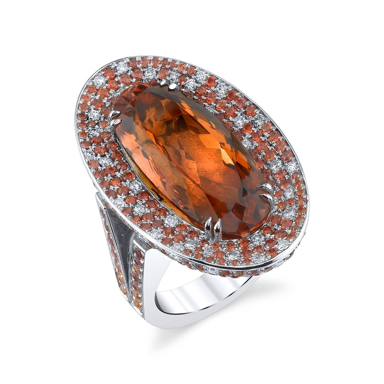 Precious Imperial Topaz set in 18 Karat White Gold, accented with White Diamonds and Orange Sapphires. GIA Certified Center Stone with a Total Weight of 21.99CT. White Diamond Quality F/VS2 with a Total Weight of 1.97CT. Orange Sapphire Weight of