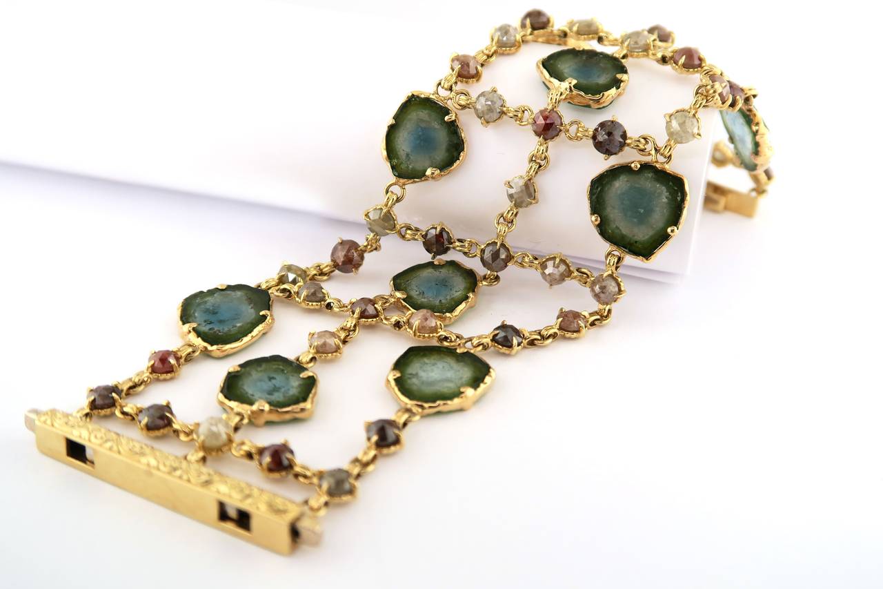 18 Karat Yellow Gold, Tourmaline Slice, and 27.87 CT Rustic Diamond Bracelet. The finished length of this bracelet is 6.75 inches.

Very few gemstones can match tourmaline's dazzling array of color. Delicately cut tourmaline slices allow us to