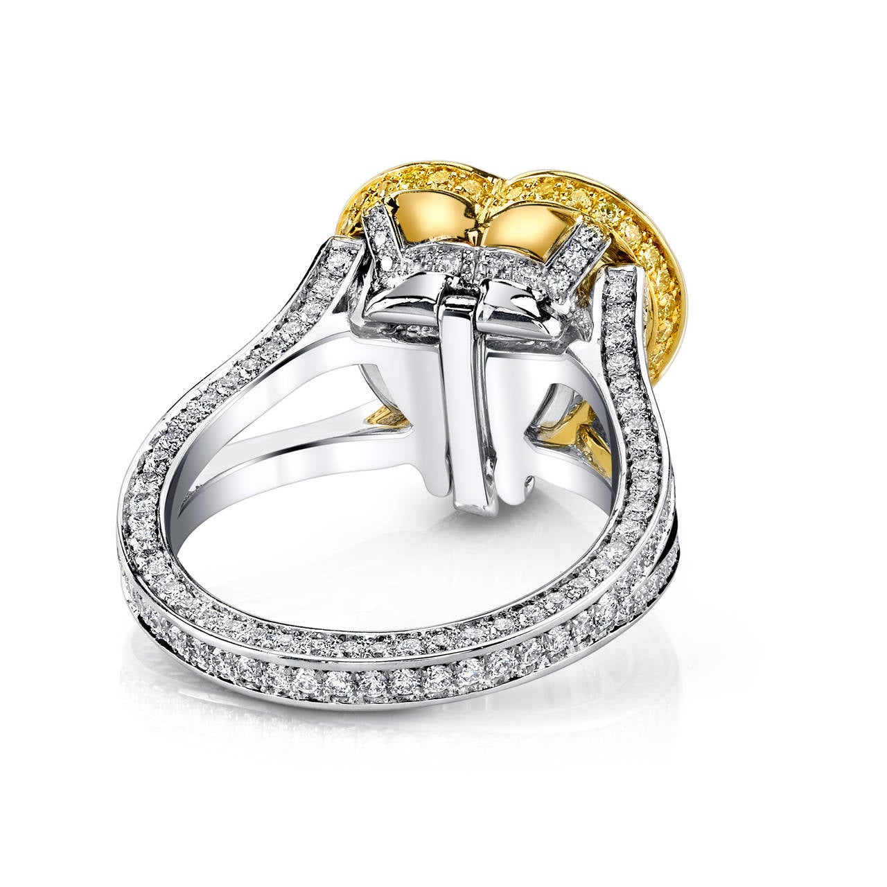 Heart Shaped, GIA Certified Fancy Light Yellow 4.41 CT Diamond set in 18 Karat White Gold and Platinum. Accented with 2.00 CT White F/VS2 Ideal Cut Diamonds and Vivid Yellow Diamonds. 18 Karat White Gold 18" Included.

This ring easily