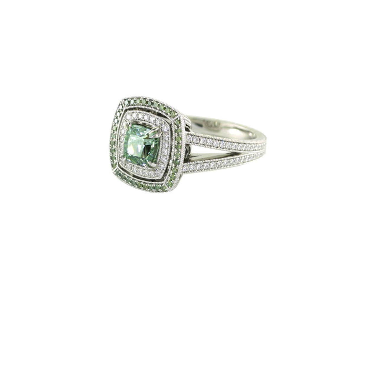 This diamond ring is one of a kind. The center stone is a GIA certified 1.50 ct modified square cut natural fancy intense green VS2 diamond. It is set in a custom made platinum mounting with a grand total of 170 side diamonds (1.27 ct of E color