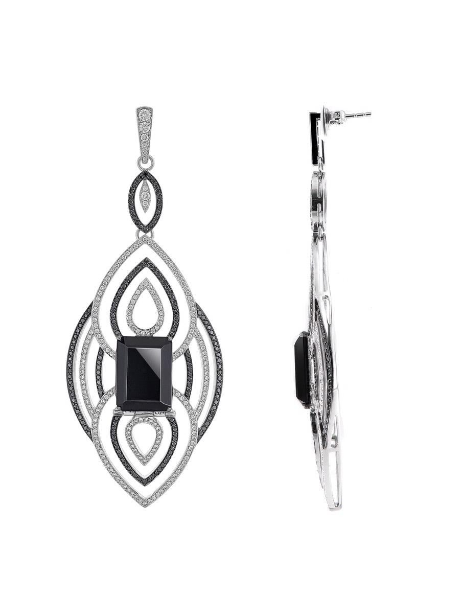 With over 12 carats of black onyx, 3 carats of vvs pave'd black and white diamonds, this pair of 18k white gold earrings showcase a geometric pattern. The shimmering two toned colours make this a timeless, classic palette. Created to move