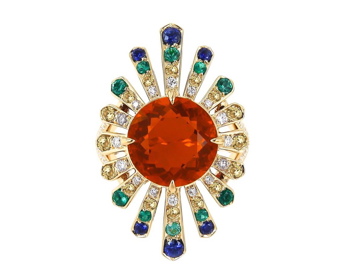 Inspired by Native American colours, this bold 18k yellow gold ring showcases a vivid Mexican fire opal as its centre stone with a total weight of 4.04 carats. Like Quetzalcoatl's feathers, the blue, yellow and green sapphires with diamonds fan out