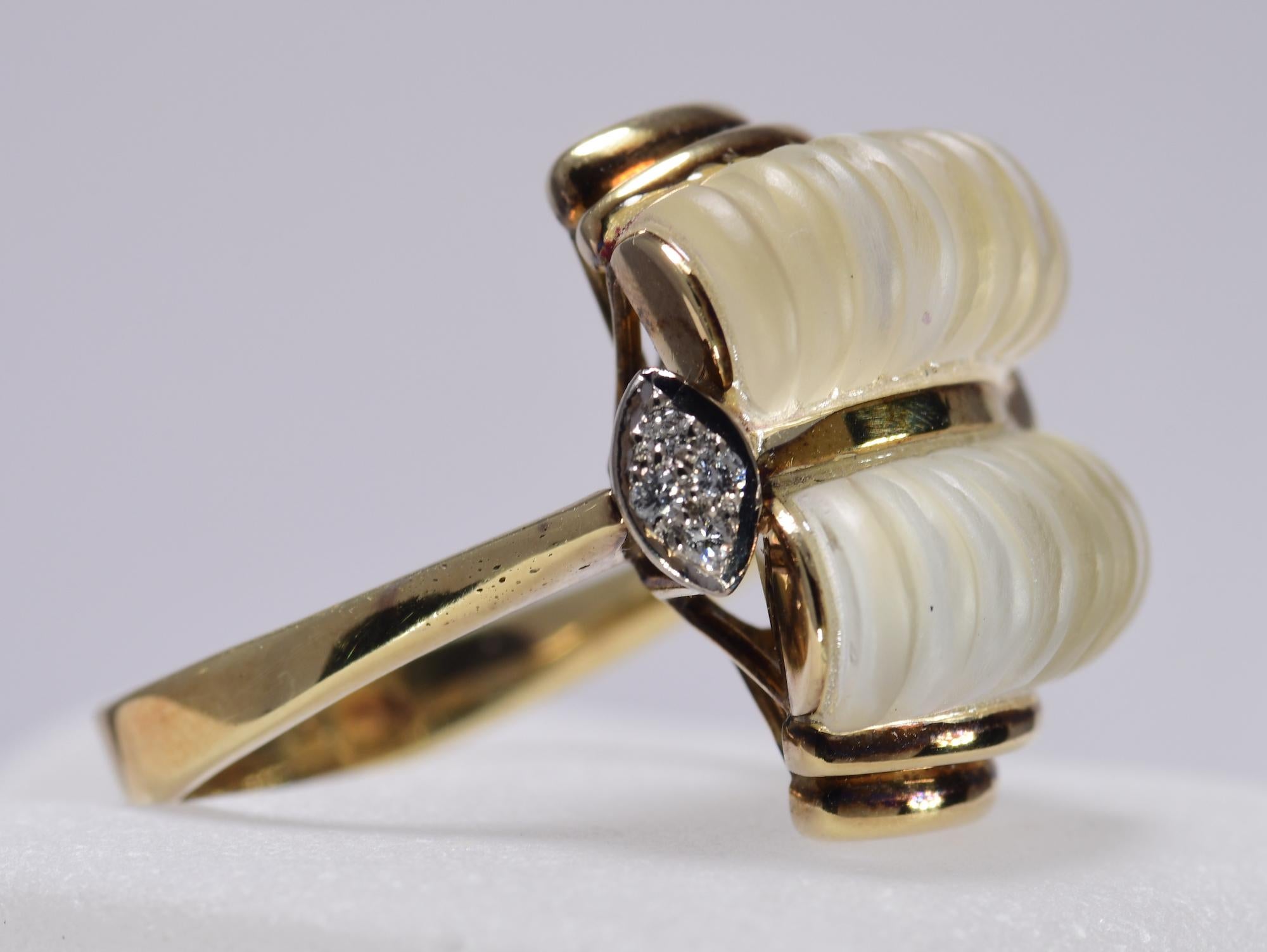 Vintage 1960's carved rock quartz ring with .12 carat total weight of diamonds. The ring is 14 karat yellow gold with a finger size of 9. Please inquire if additional sizing is needed. The ring weighs 12.2 grams and is in excellent condition.