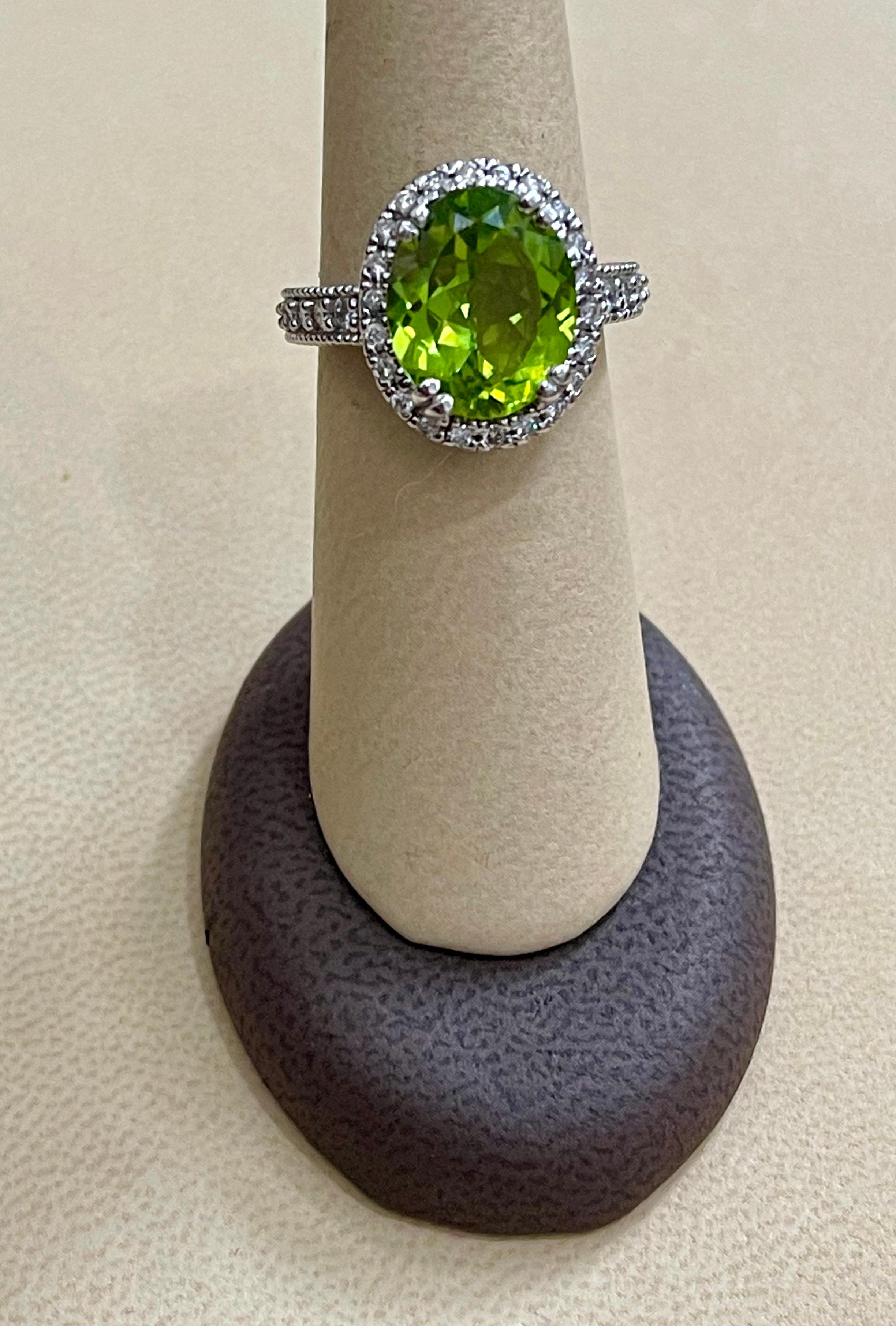 Women's 7 Carat Oval Peridot and 1.2 Carat Diamonds 14 Karat White Gold Cocktail Ring For Sale